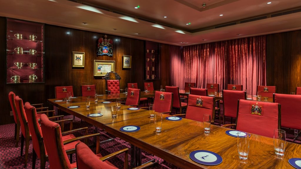 Formal boardroom with wood-paneling for executive meetings and corporate governance events.