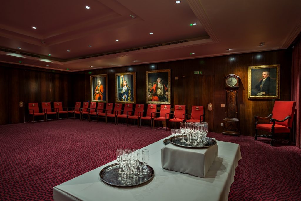 Traditional courtroom boardroom with red seating for VIP meetings and formal events.