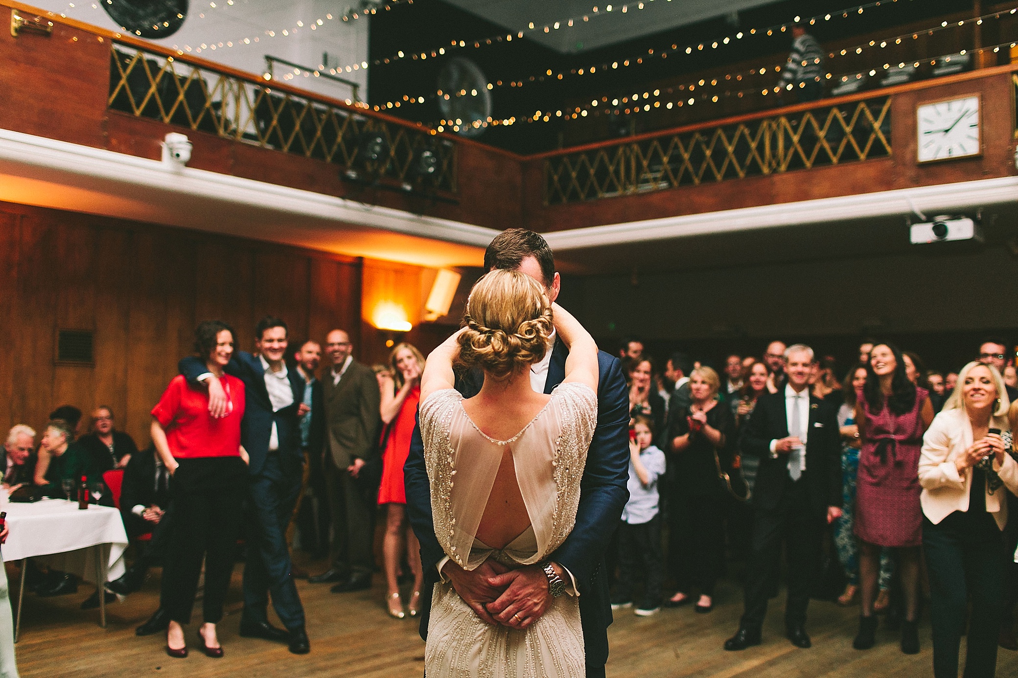Couple's first dance at a lively wedding reception in Conway Hall, capturing joyful moments.