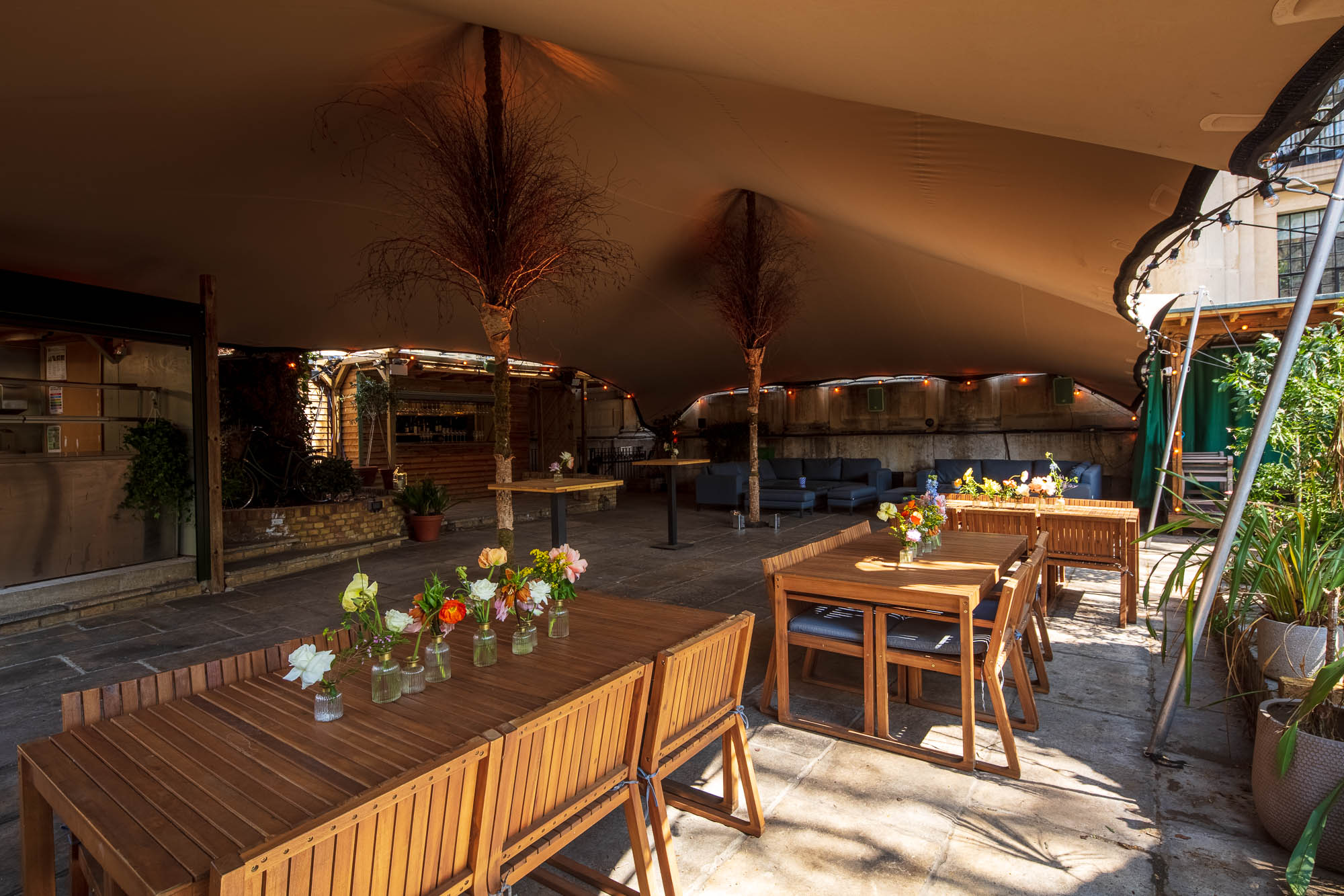 Elegant tented outdoor event space at God's Garden, One Marylebone, perfect for gatherings.