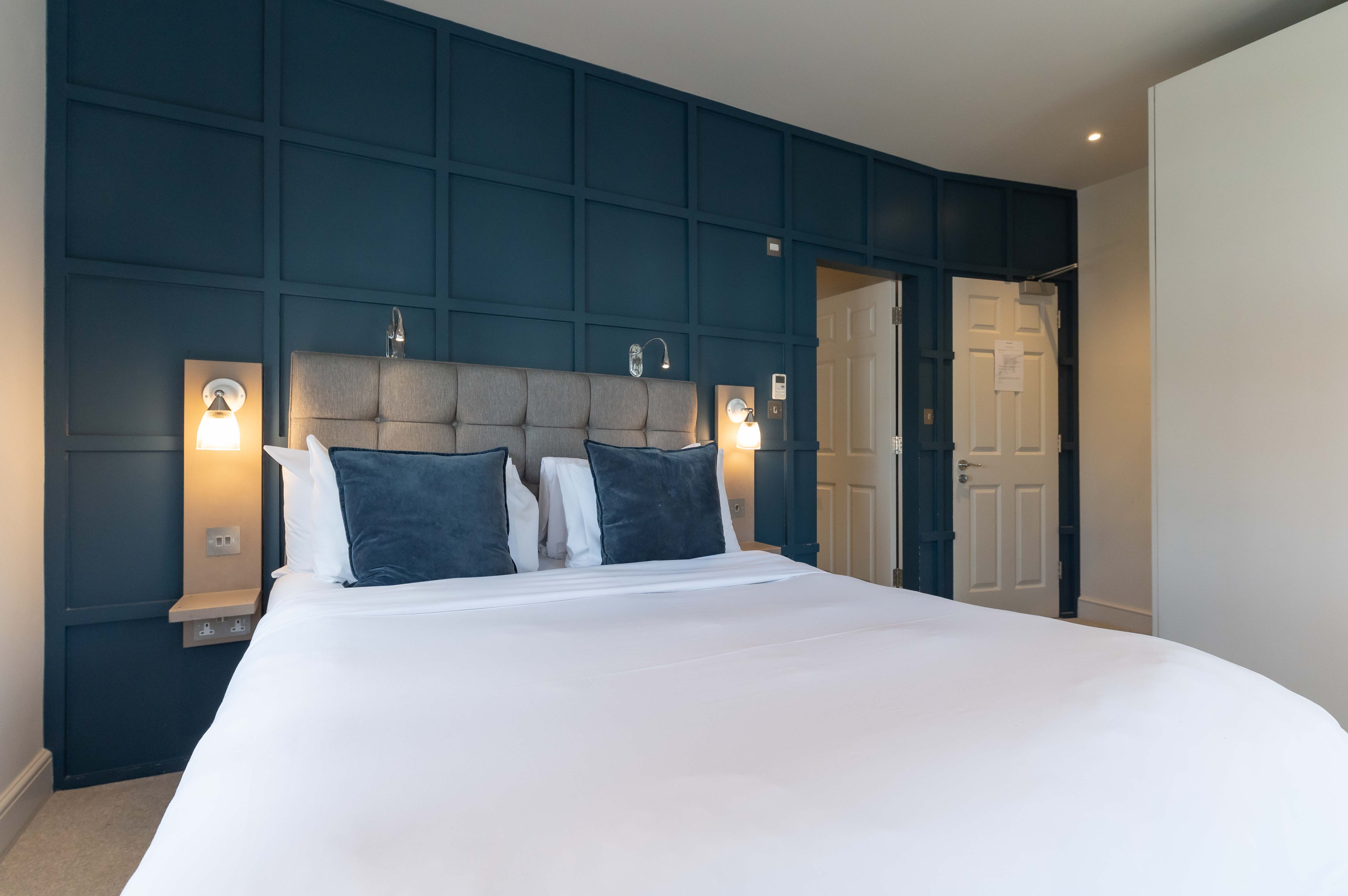 Modern hotel room with stylish headboard for full venue hire in Barnes. Ideal for events.