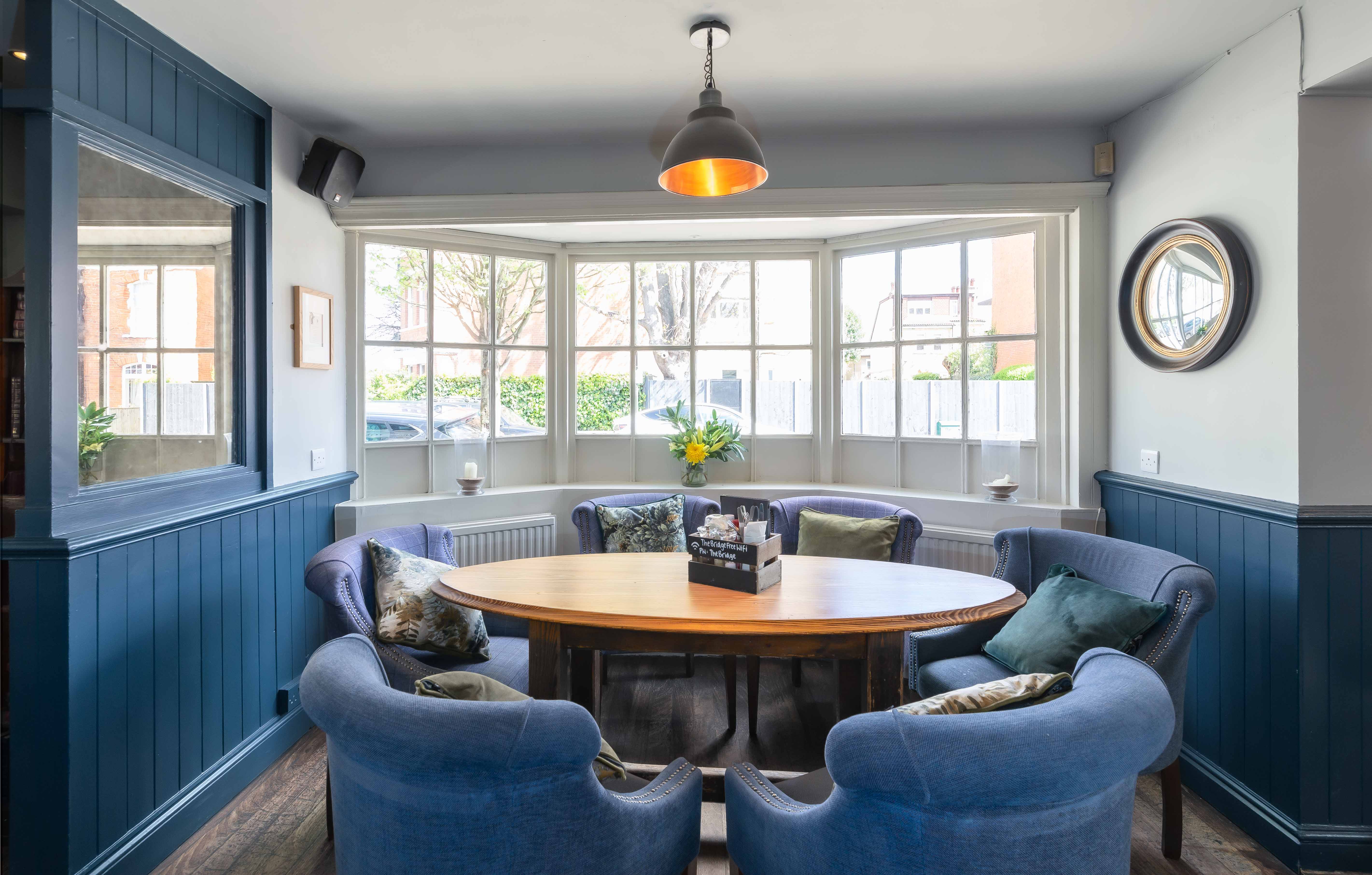 Cozy meeting space with round table for intimate gatherings at The Bridge, Barnes.