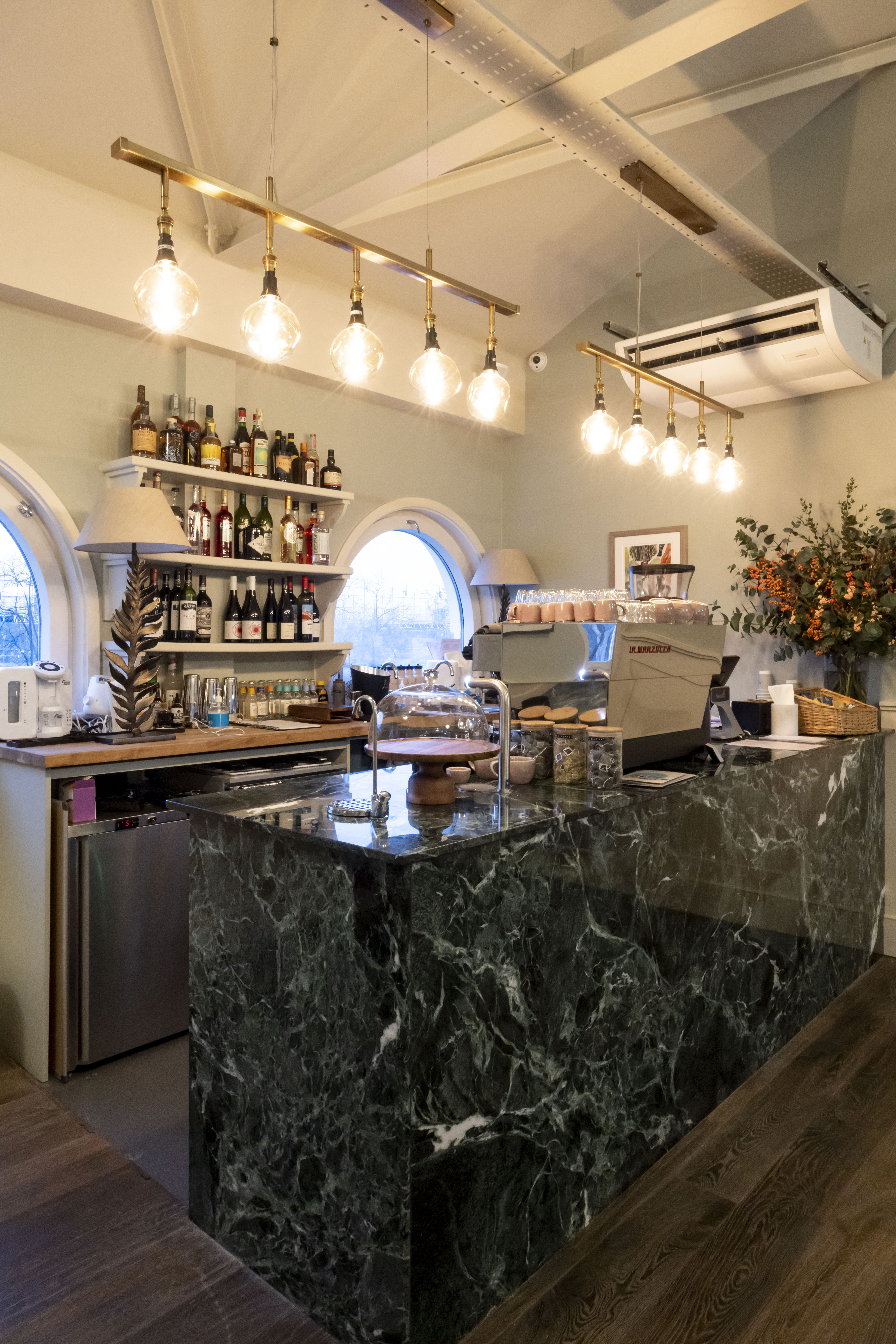 Stylish café setup with marble counter for networking events in Jaego's House.