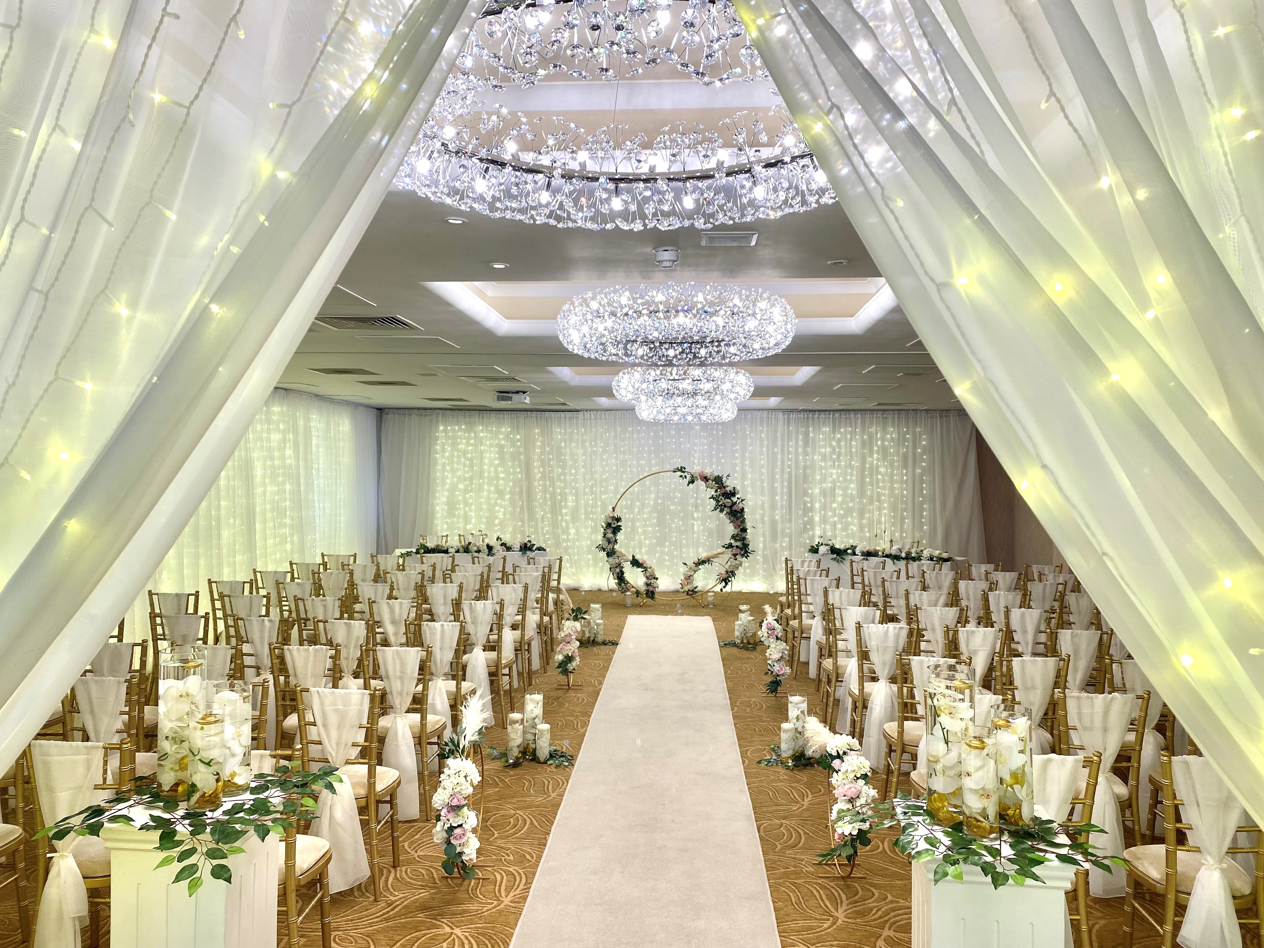 Barton Suite wedding venue with elegant drapery and floral arch for romantic ceremonies.