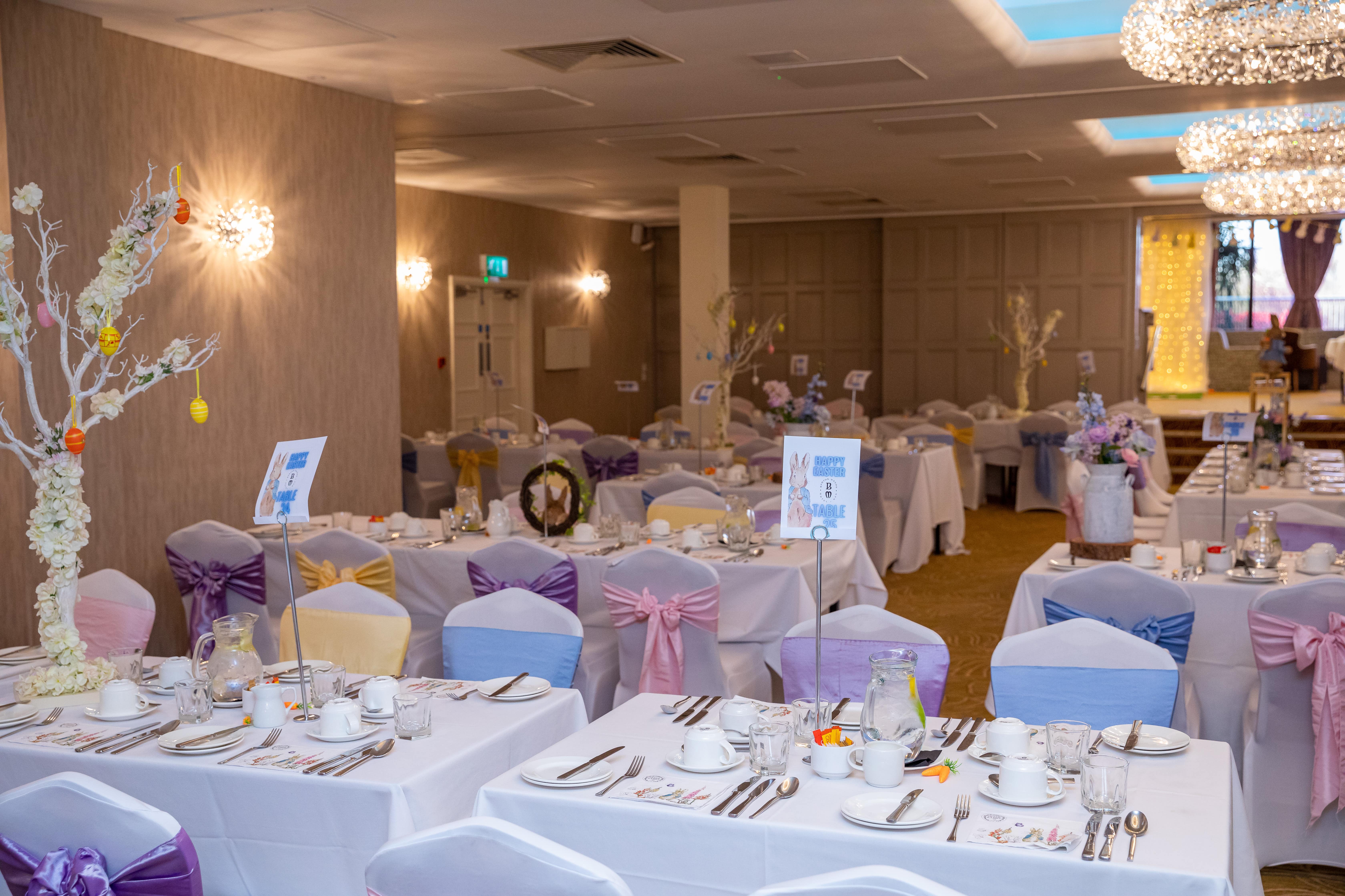 Barton Suite event space with elegant tables and pastel chair sashes for weddings or corporate events.