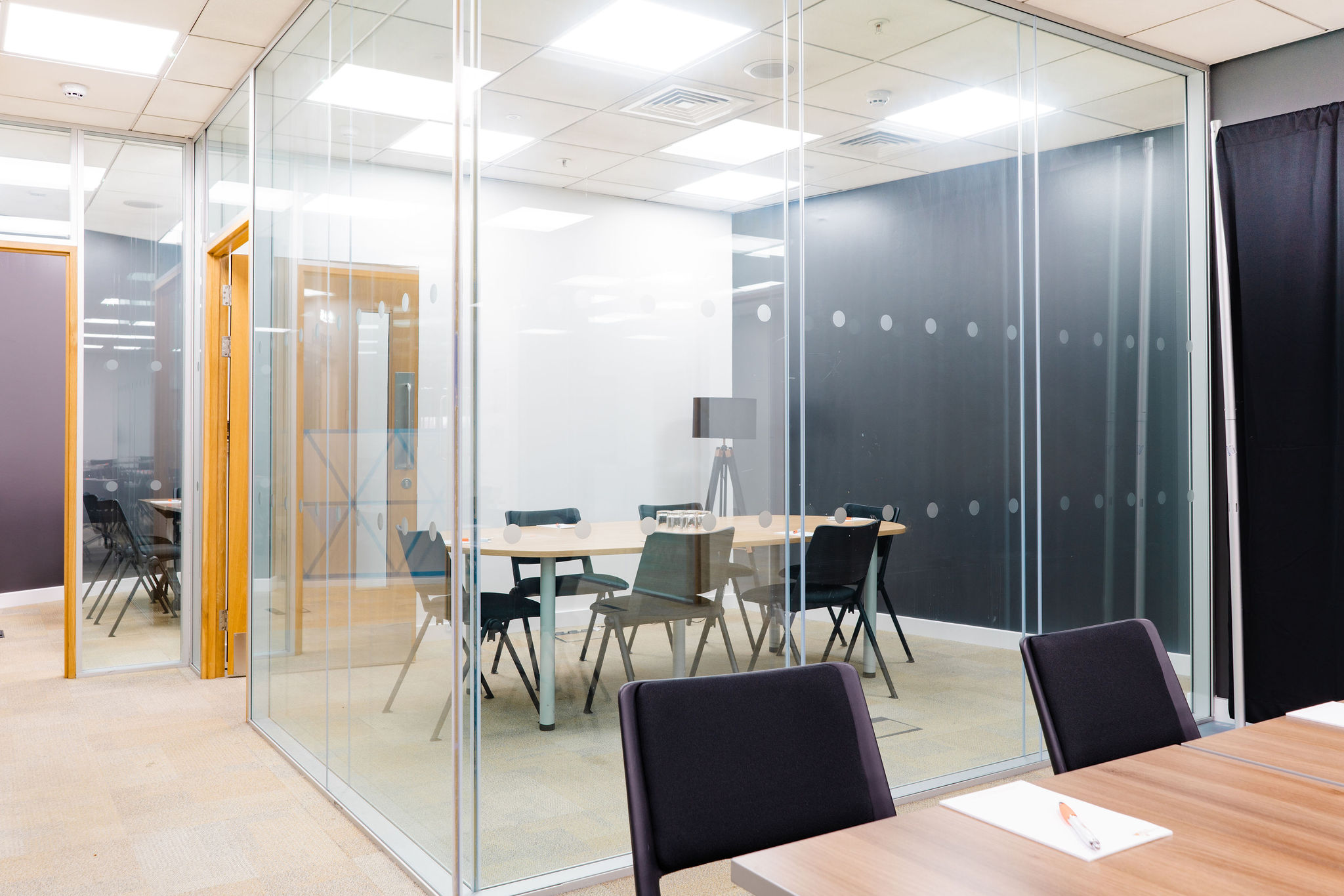 Modern meeting room at Millennium Point with glass walls for collaboration and brainstorming.