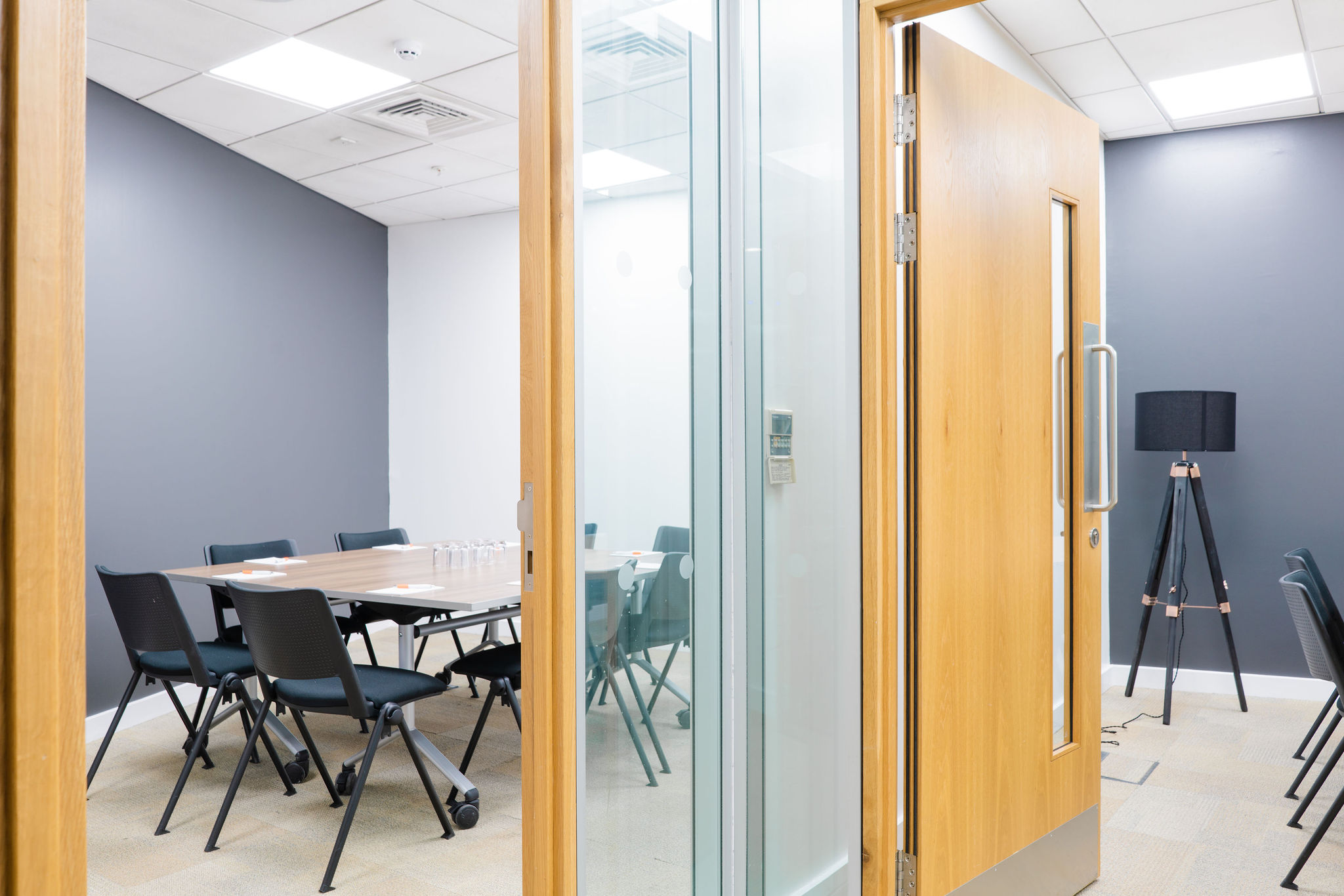 Modern meeting room at Millennium Point with glass door, ideal for brainstorming sessions.