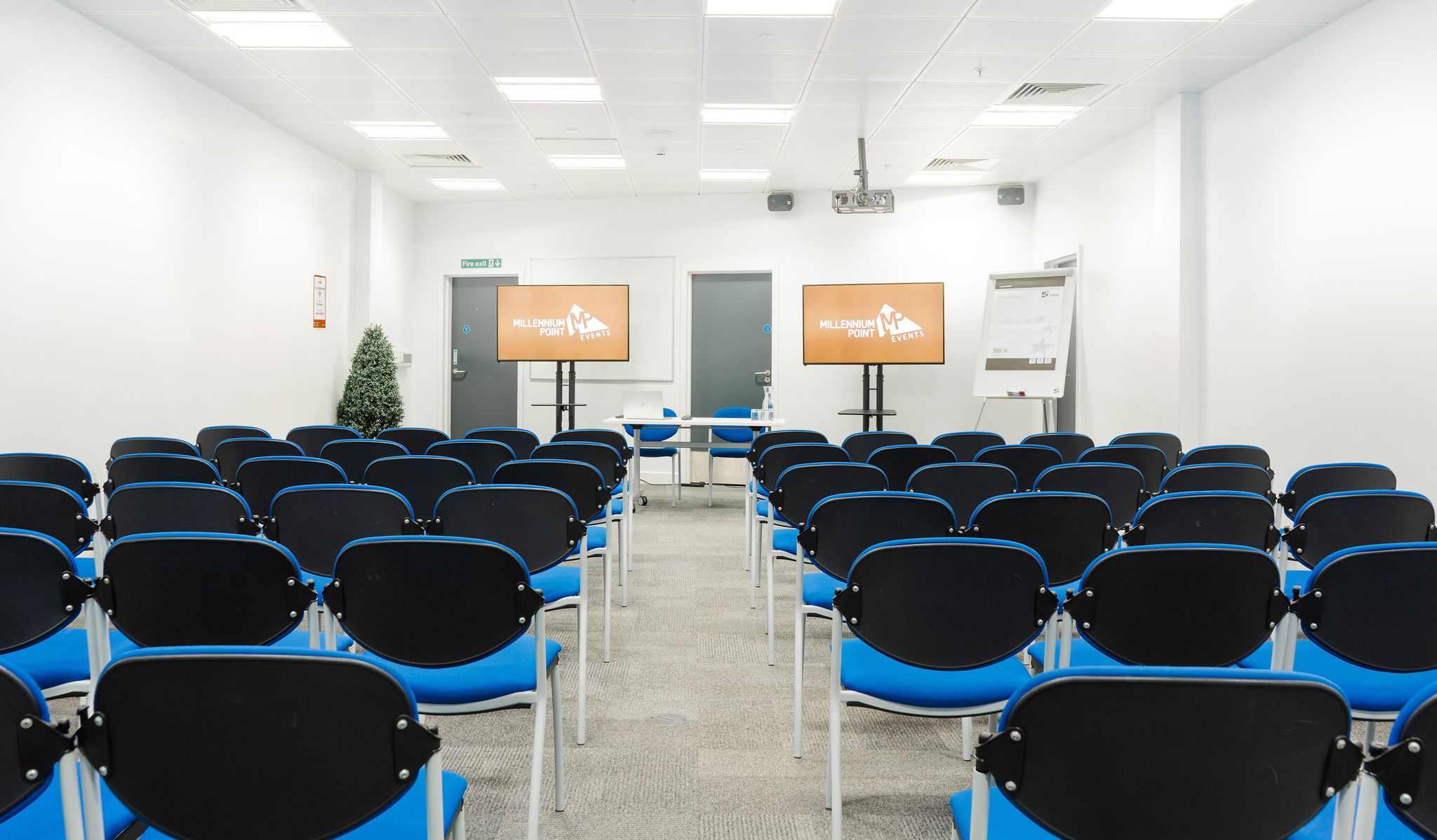 Curzon Rooms meeting space with blue chairs, ideal for presentations and events.