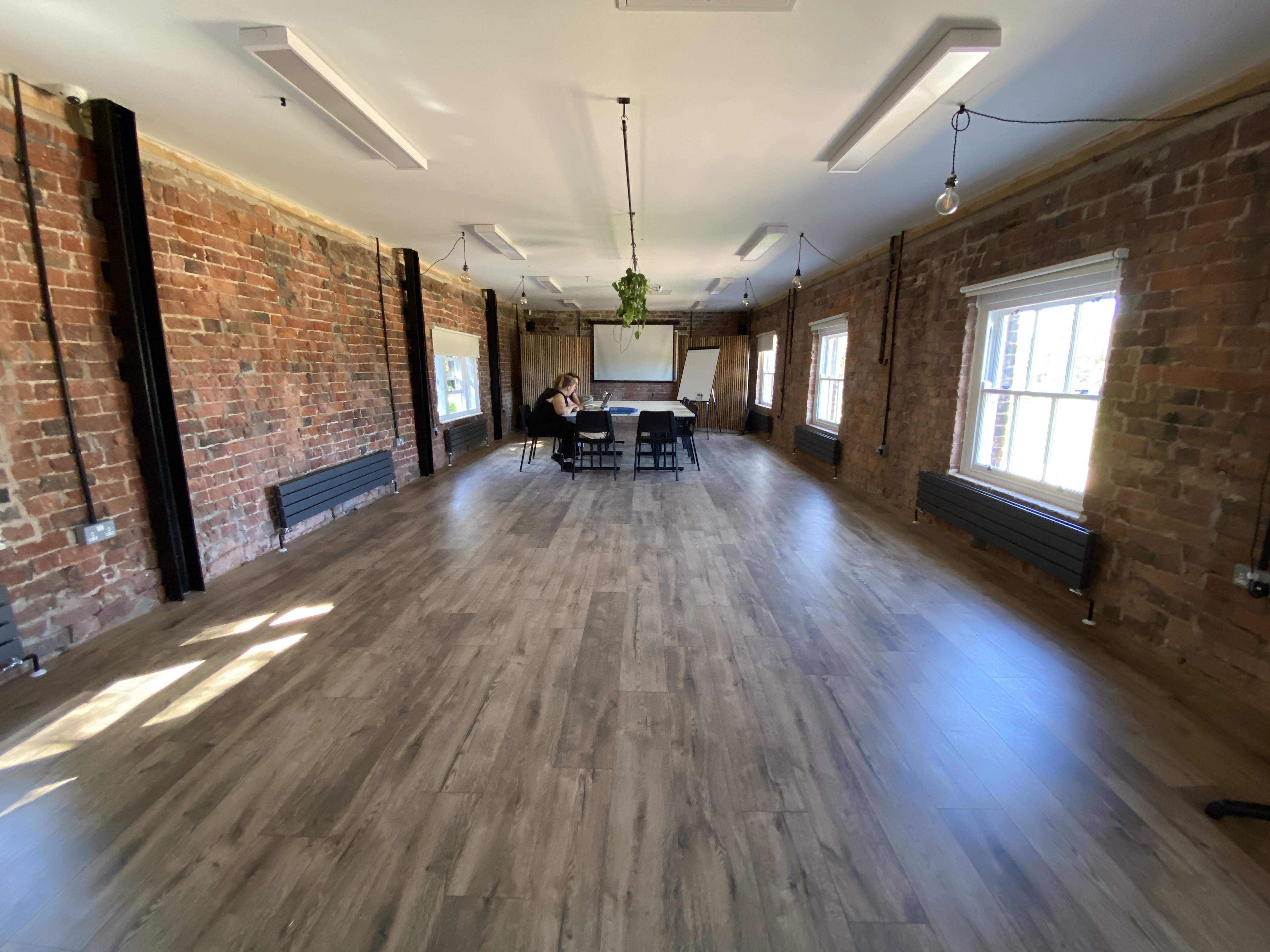 Loft event space in Bowring Park with exposed brick, ideal for meetings and workshops.