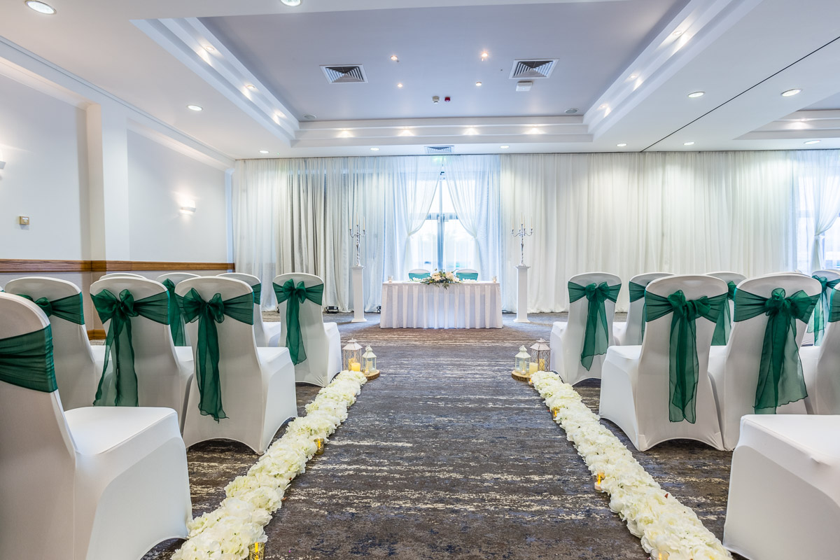 Lydiard Suite wedding venue with elegant white chairs and floral pathway at DoubleTree Swindon.
