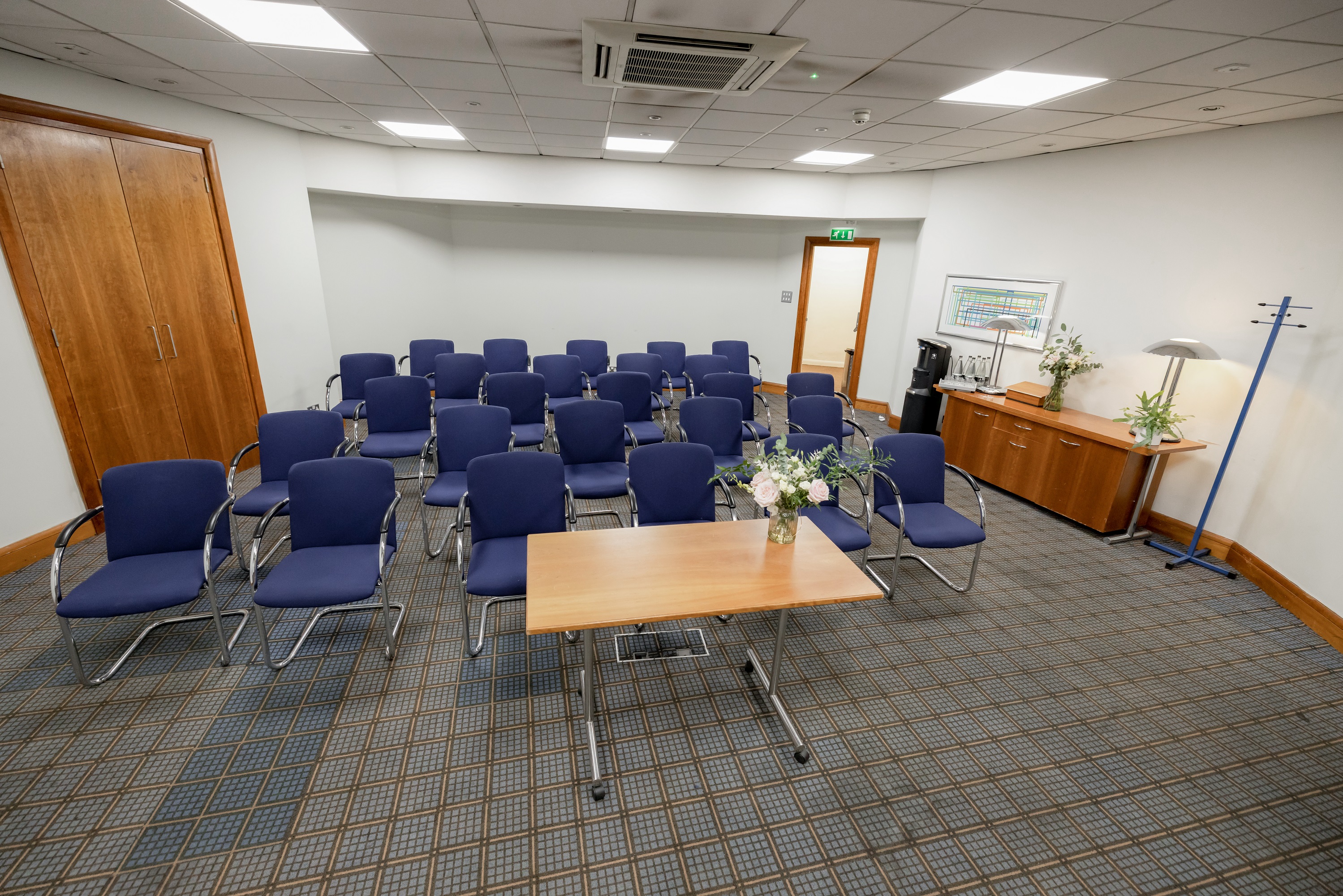 Meeting room at Best Western London Heathrow Ariel, featuring blue chairs for events.