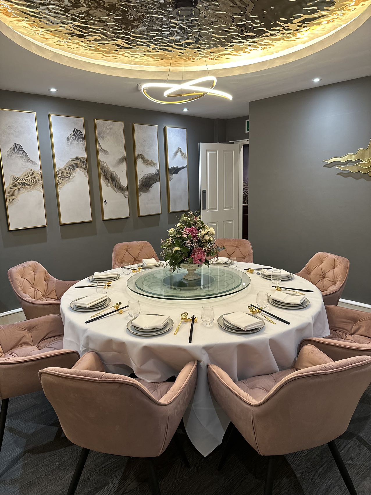 Elegant round table with pink chairs for upscale corporate dinners and private parties.