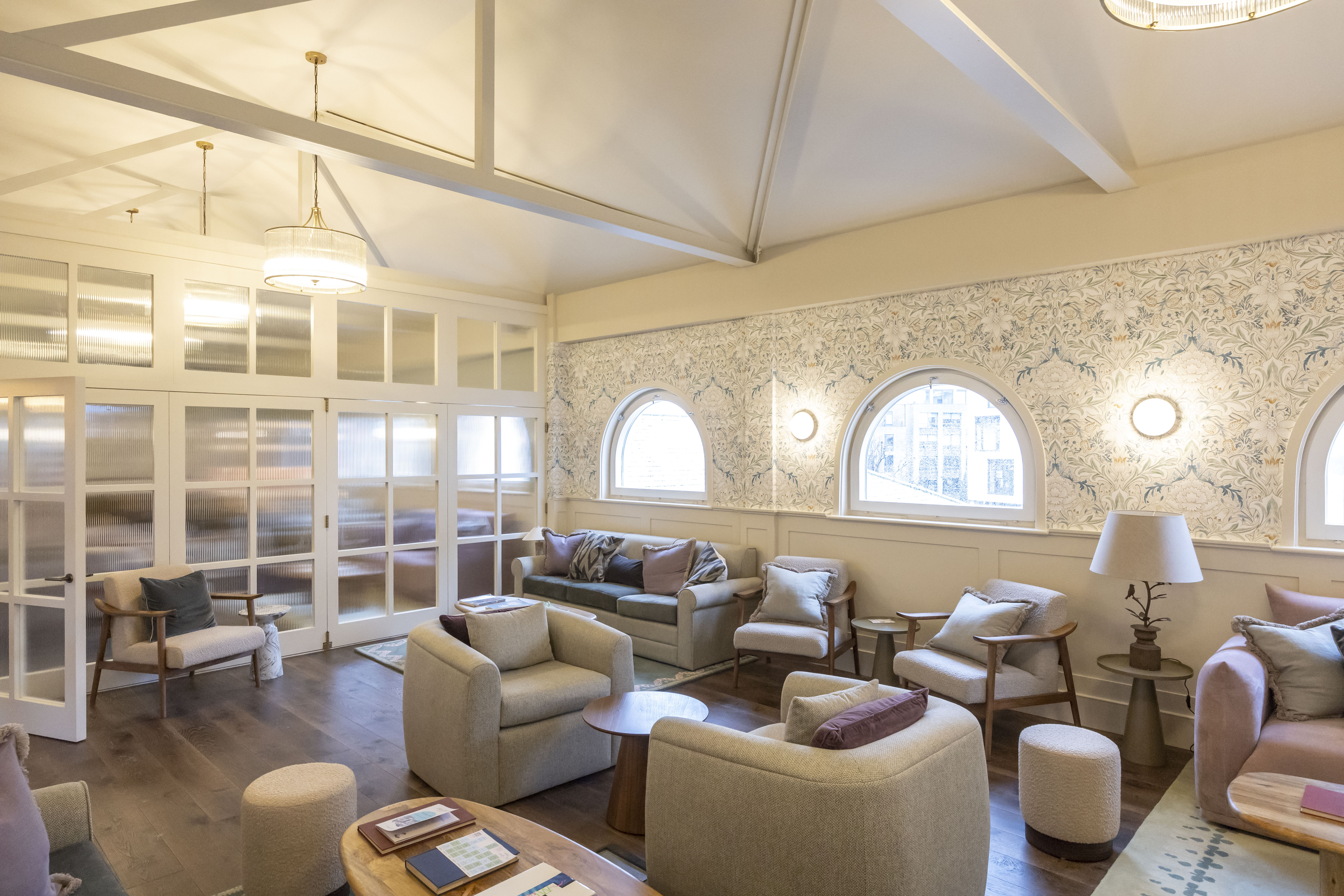 Stylish living room with arched windows, perfect for networking events and casual gatherings.