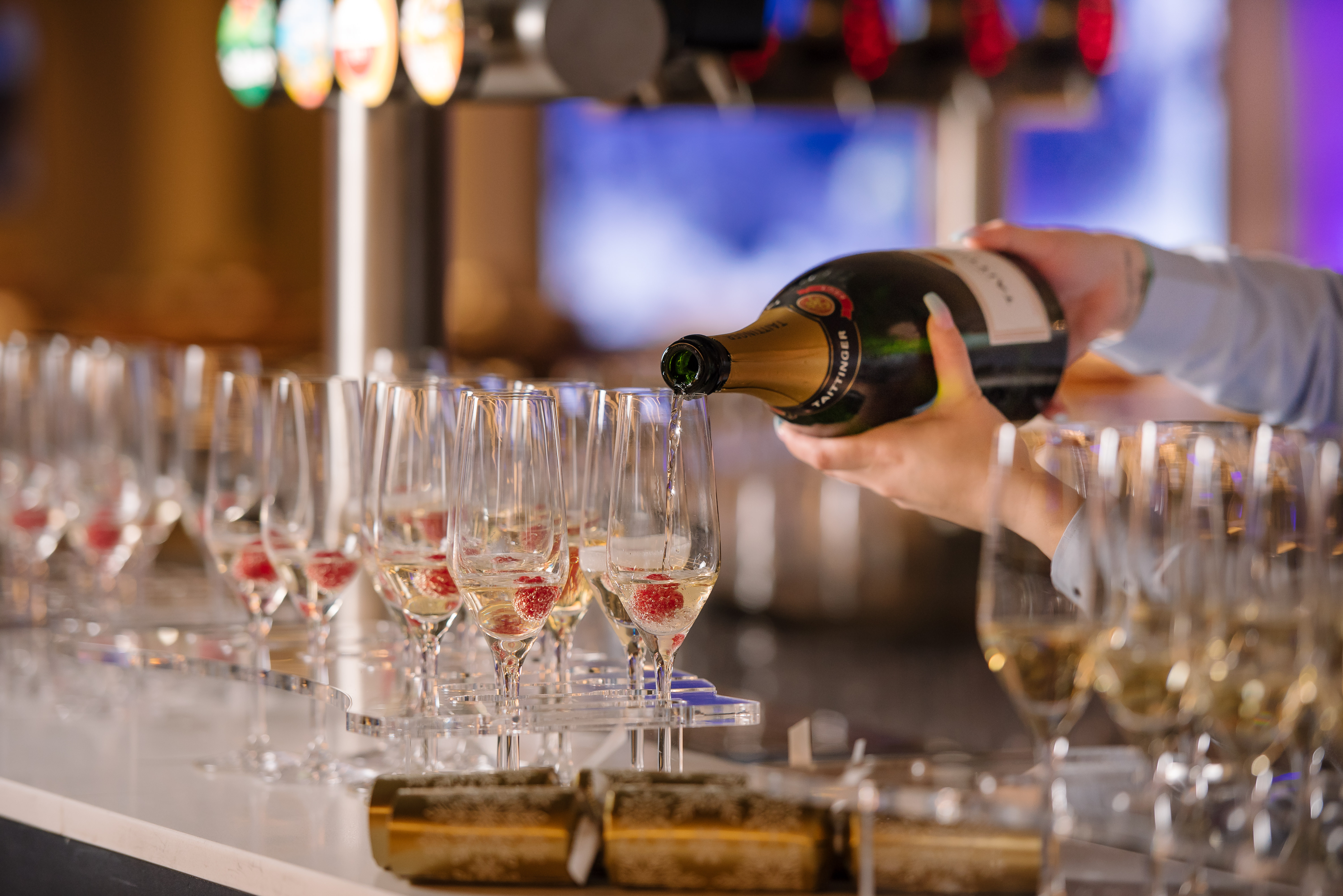 Champagne service at a festive corporate Christmas party in Tottenham Hotspur Stadium.