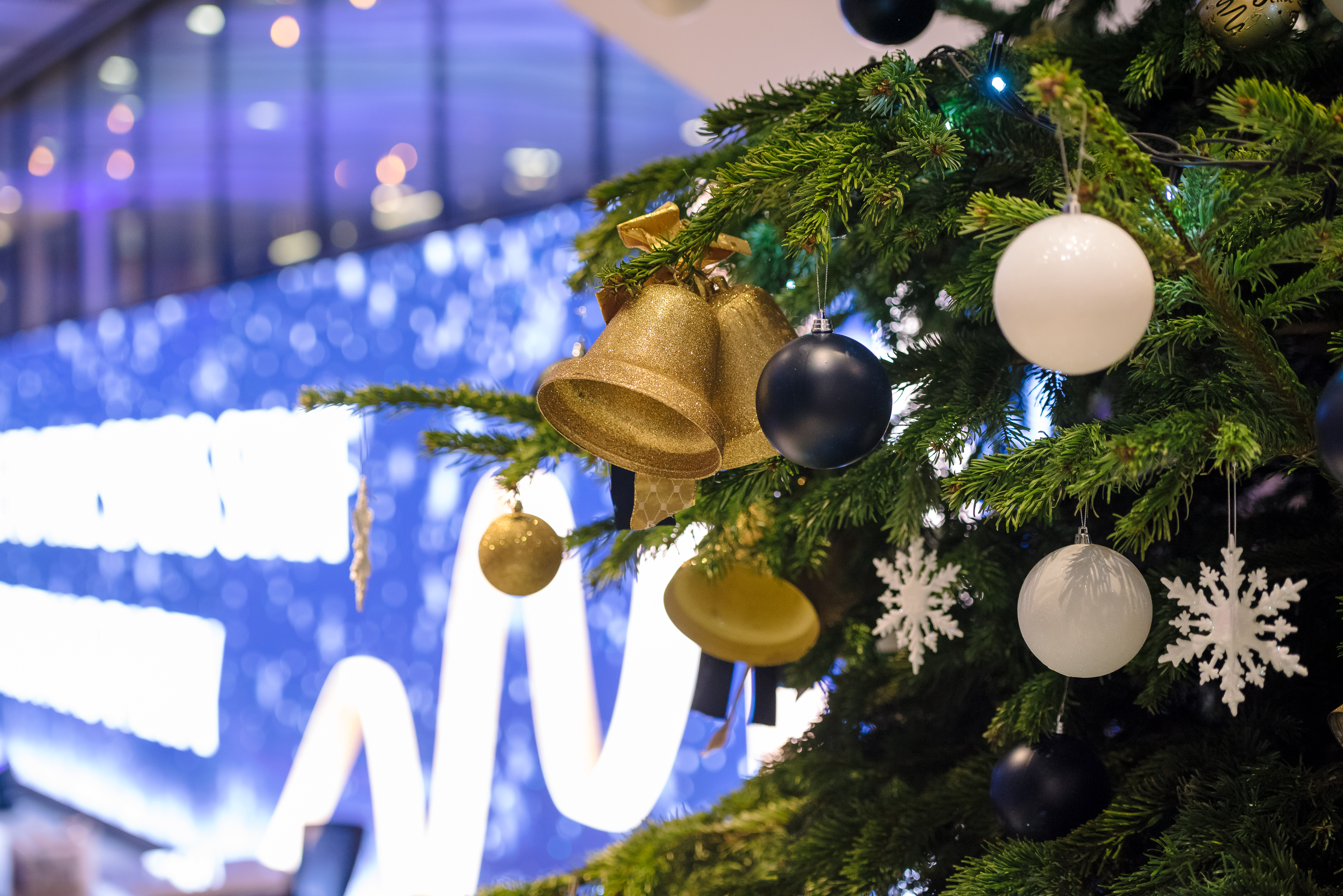 Christmas tree with gold ornaments at Tottenham Hotspur Stadium holiday event.