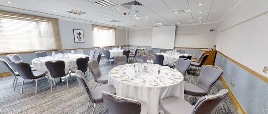Hawksworth Suite meeting room with round tables, ideal for corporate events and presentations.