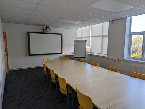 Main Hall in Rethink Rebuild Society, bright meeting room with large table for workshops.