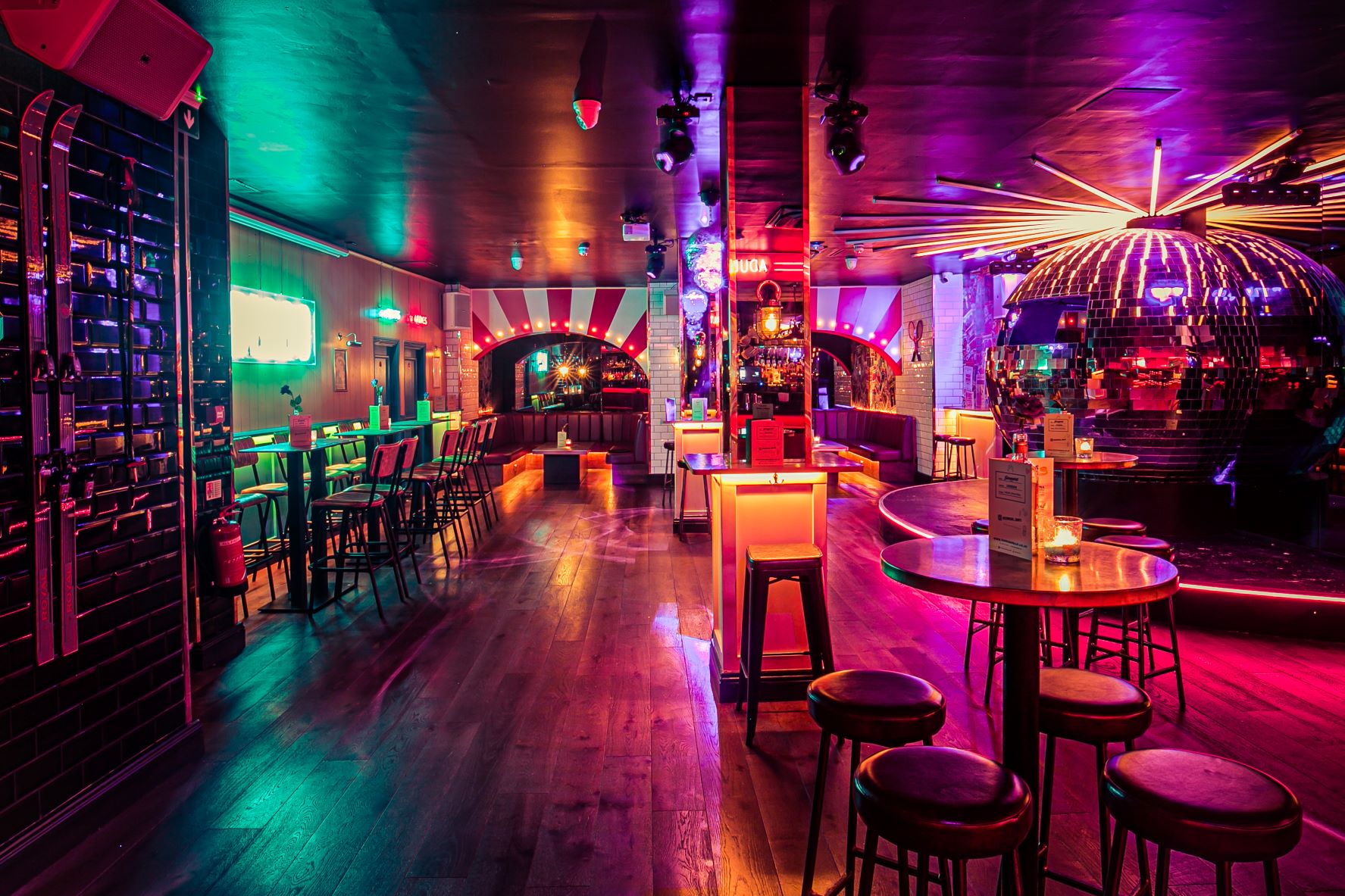 Vibrant event space with dynamic lighting ideal for cocktail parties and themed events.