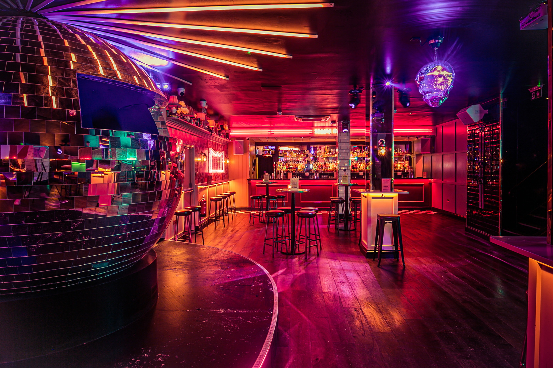 Vibrant event space with disco ball, ideal for lively gatherings and cocktail receptions.