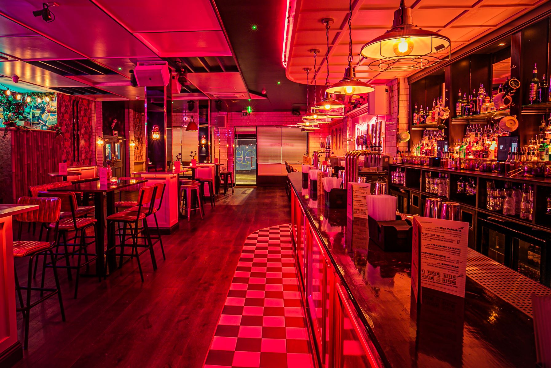 Vibrant bar with neon lighting, perfect for networking events and gatherings.