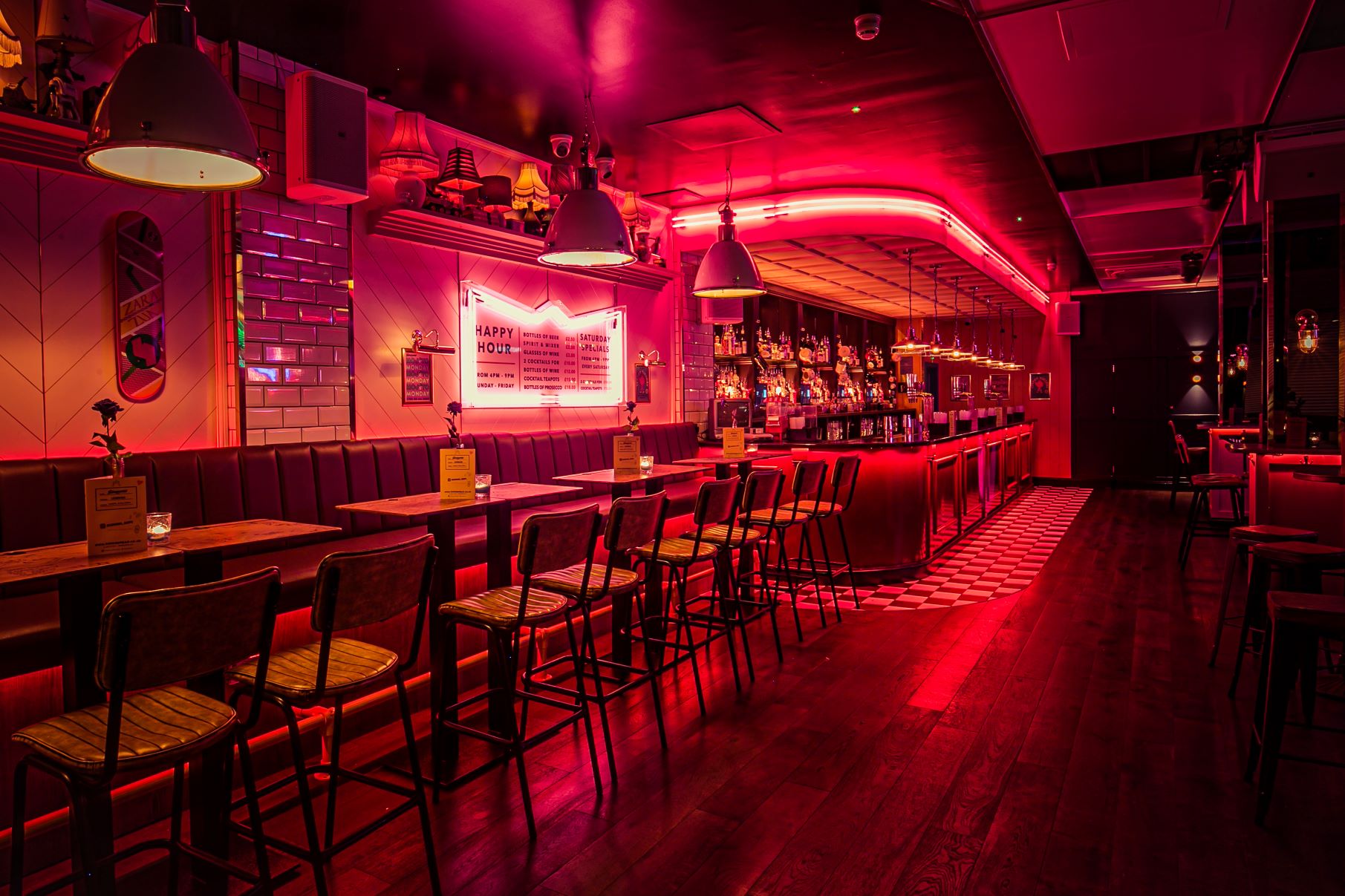 Stylish bar with pink lighting, ideal for cocktail parties and networking events.