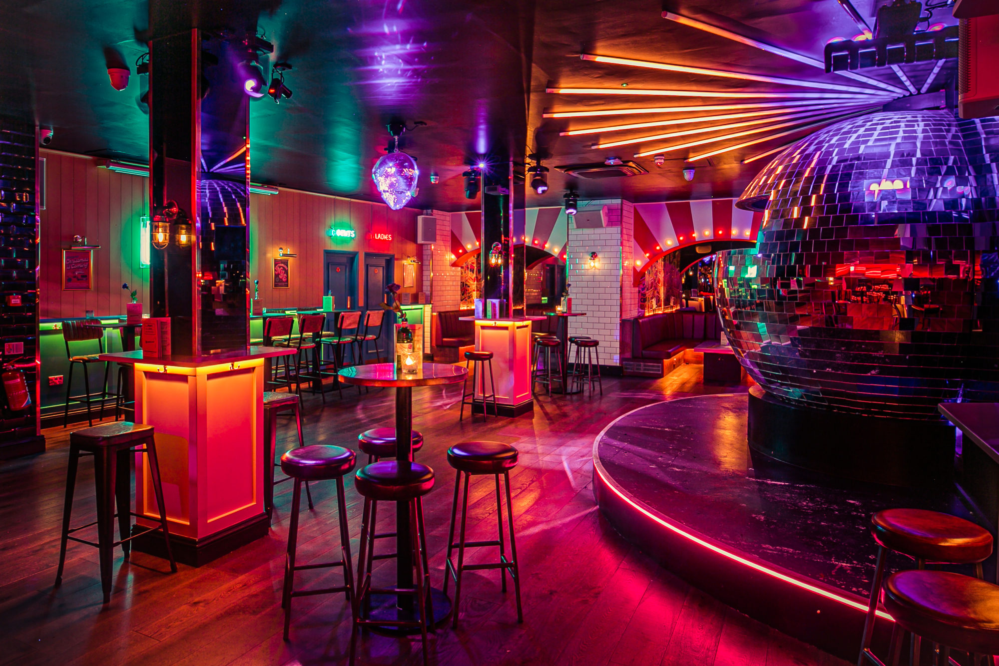 Vibrant event space with disco ball for cocktail receptions and themed events.