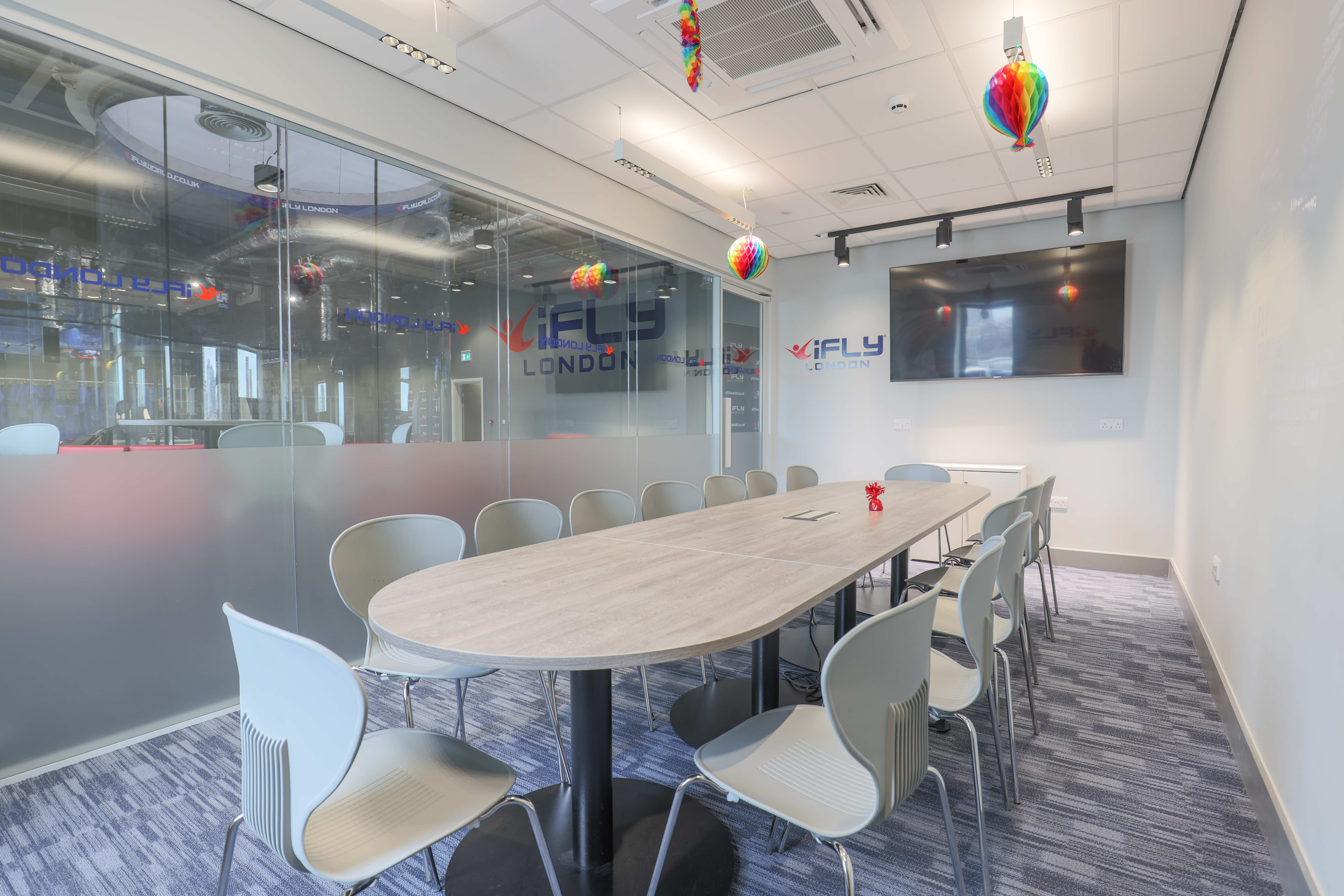 Modern conference room at iFLY Indoor Skydiving, ideal for meetings and brainstorming.
