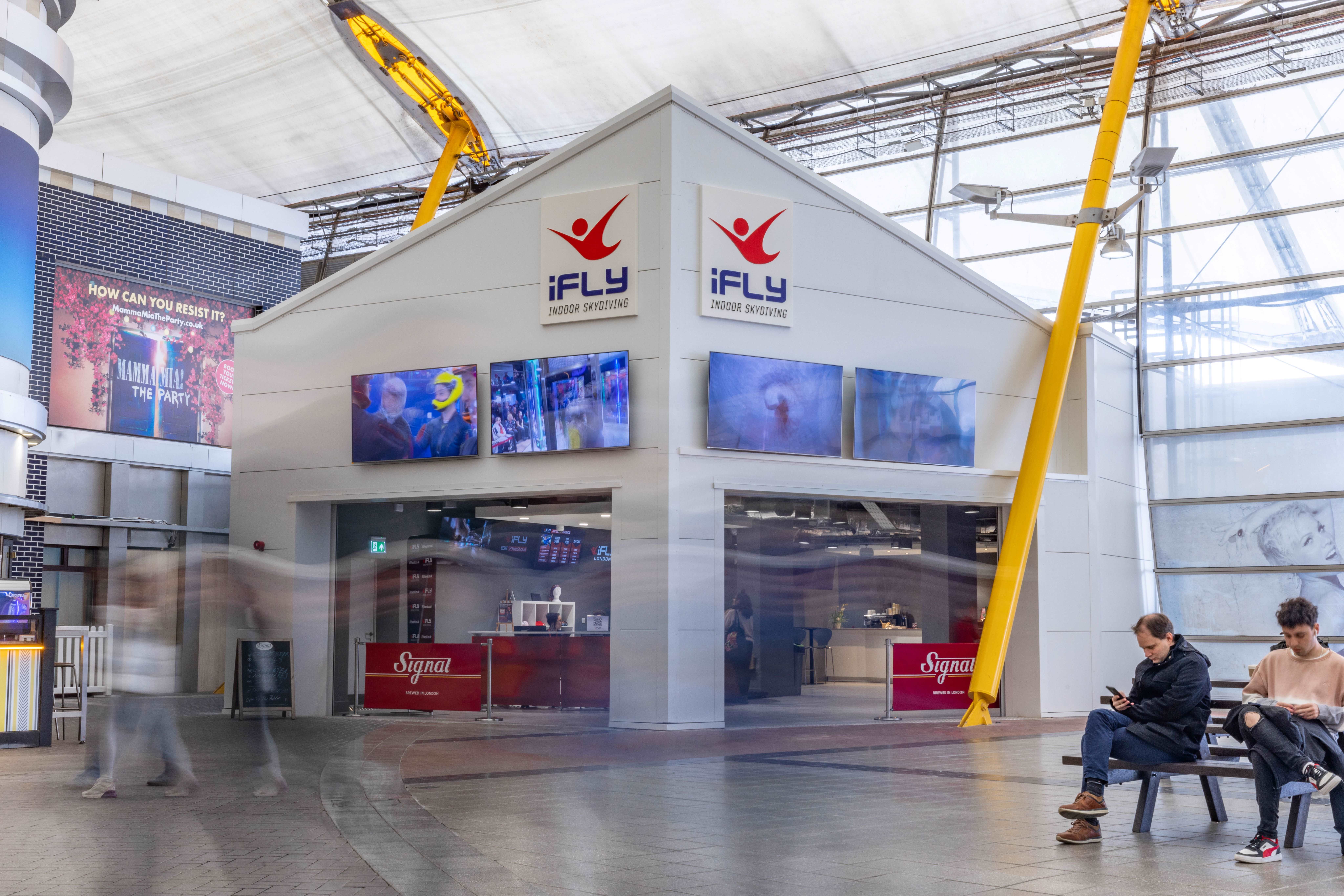 iFLY Indoor Skydiving conference room with large screens for engaging events and promotions.