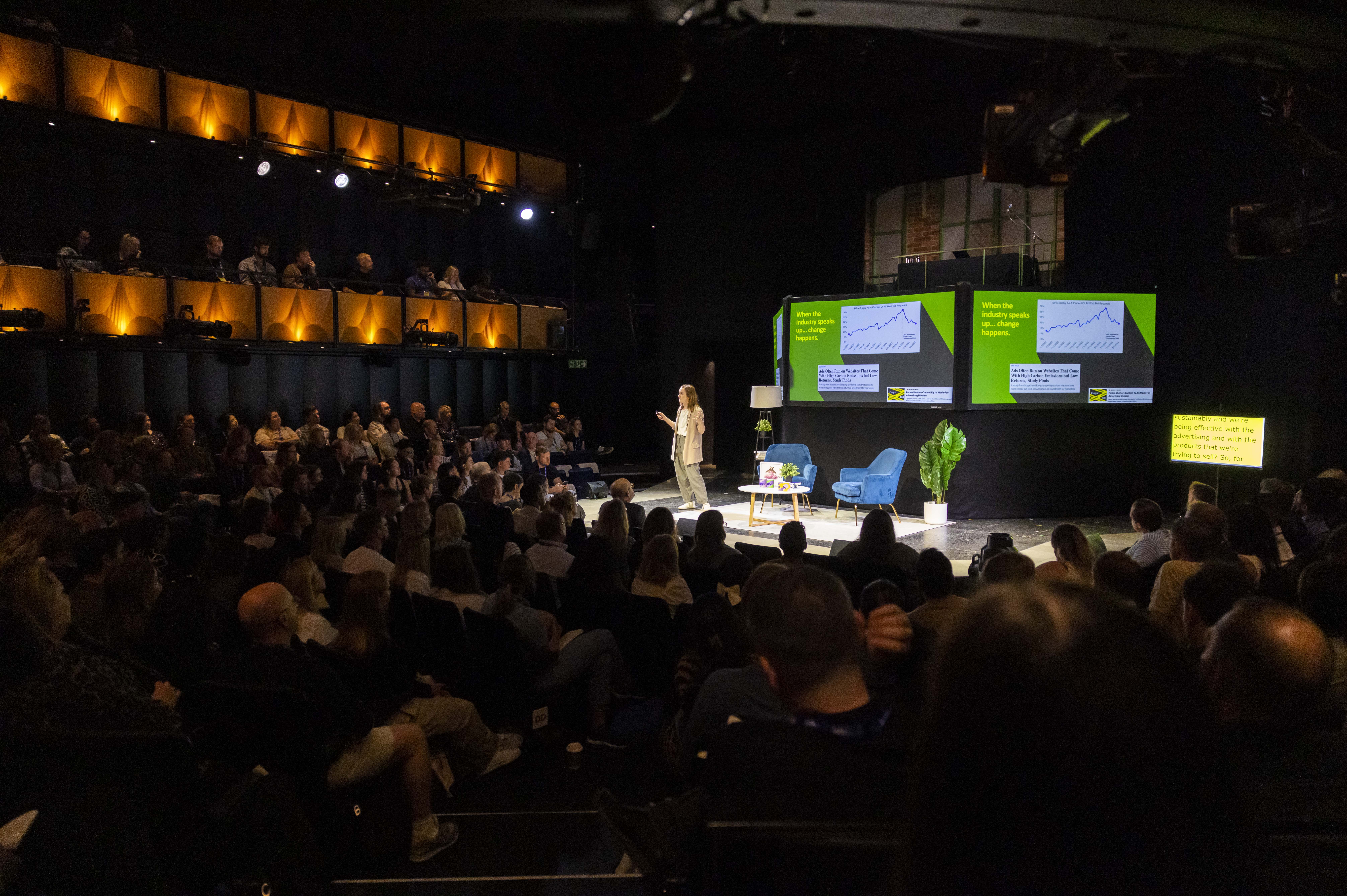 Sohoplace theatre event with speaker engaging audience in modern venue setting.