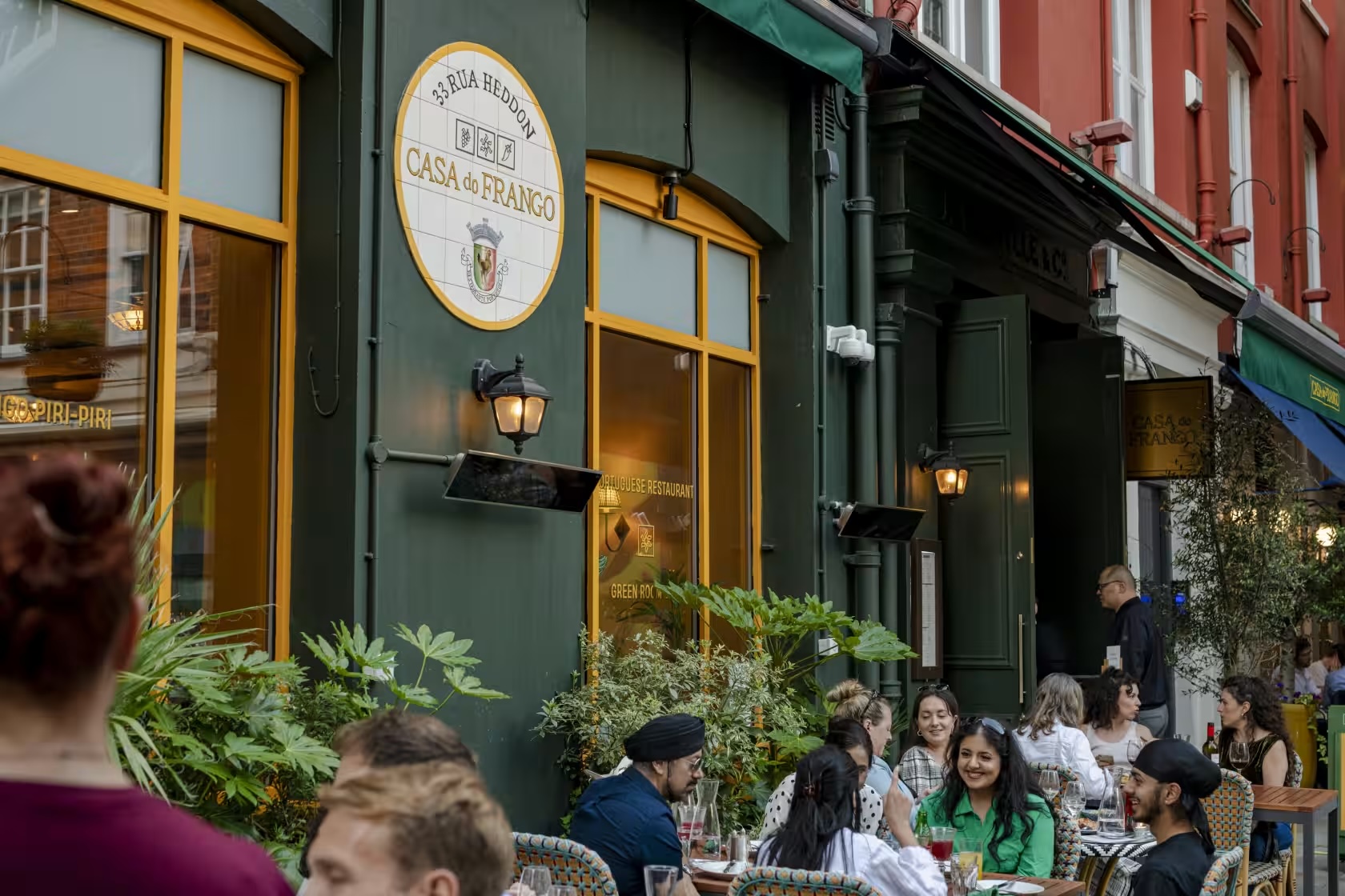 Vibrant outdoor dining at The Green Room bar, perfect for summer gatherings and events.