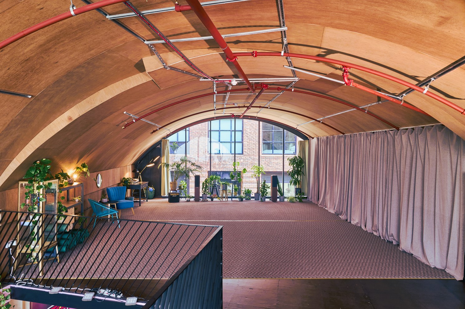 Modern arched event space with natural light for meetings and gatherings.