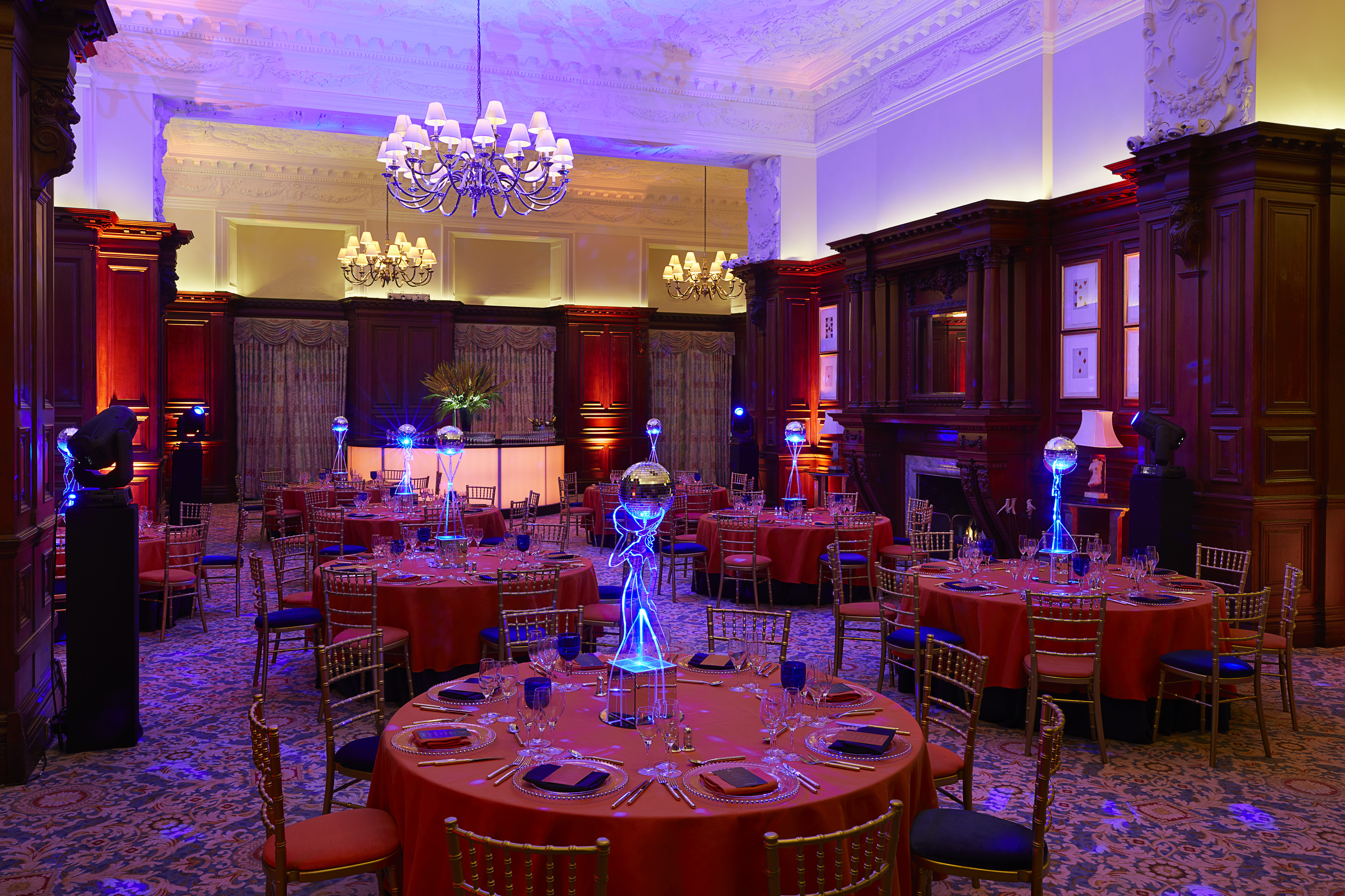 Elegant banquet room with orange linens, ideal for upscale galas and corporate dinners.