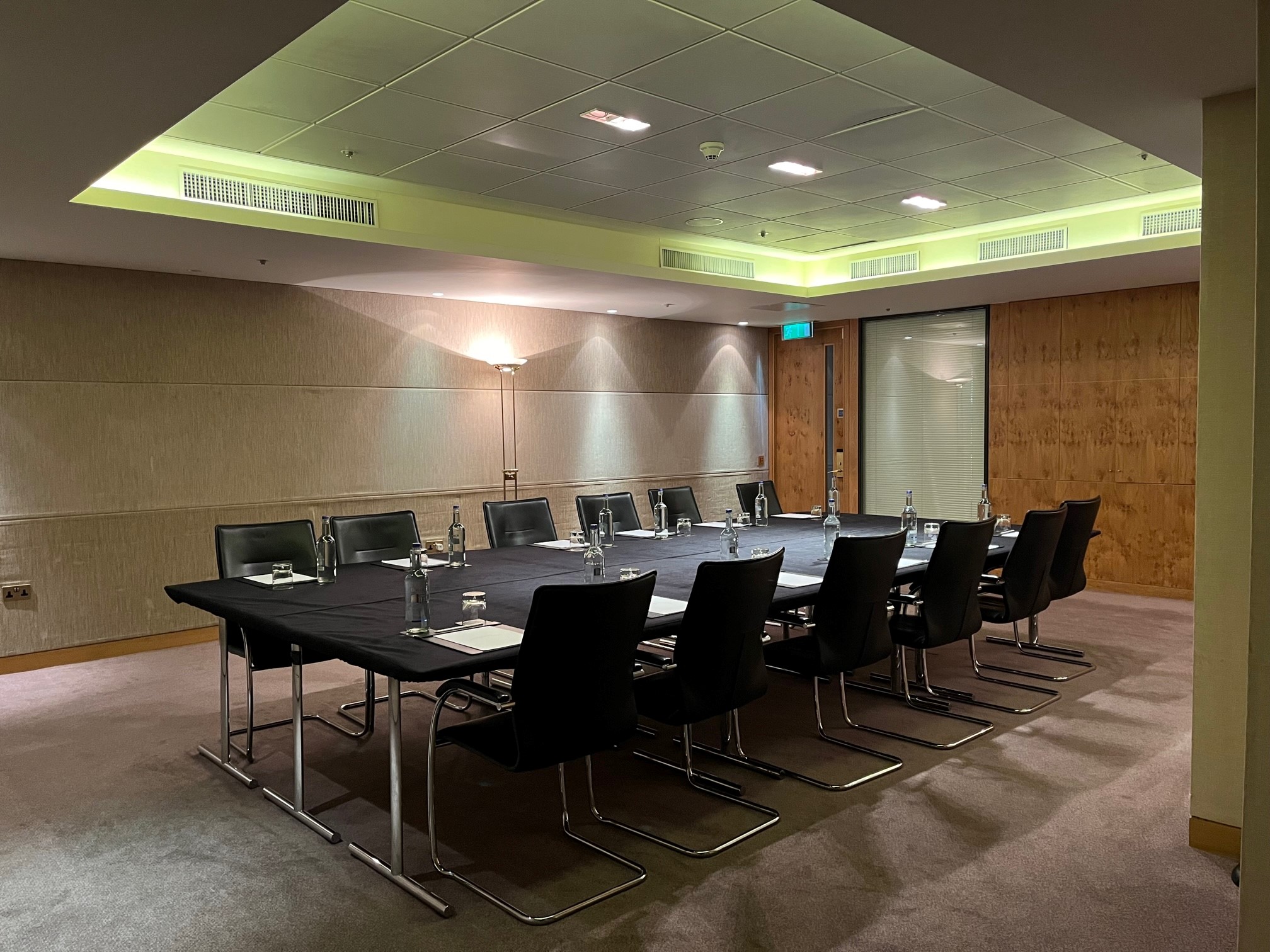 Landmark Rooms meeting space with sleek black table, ideal for board meetings.