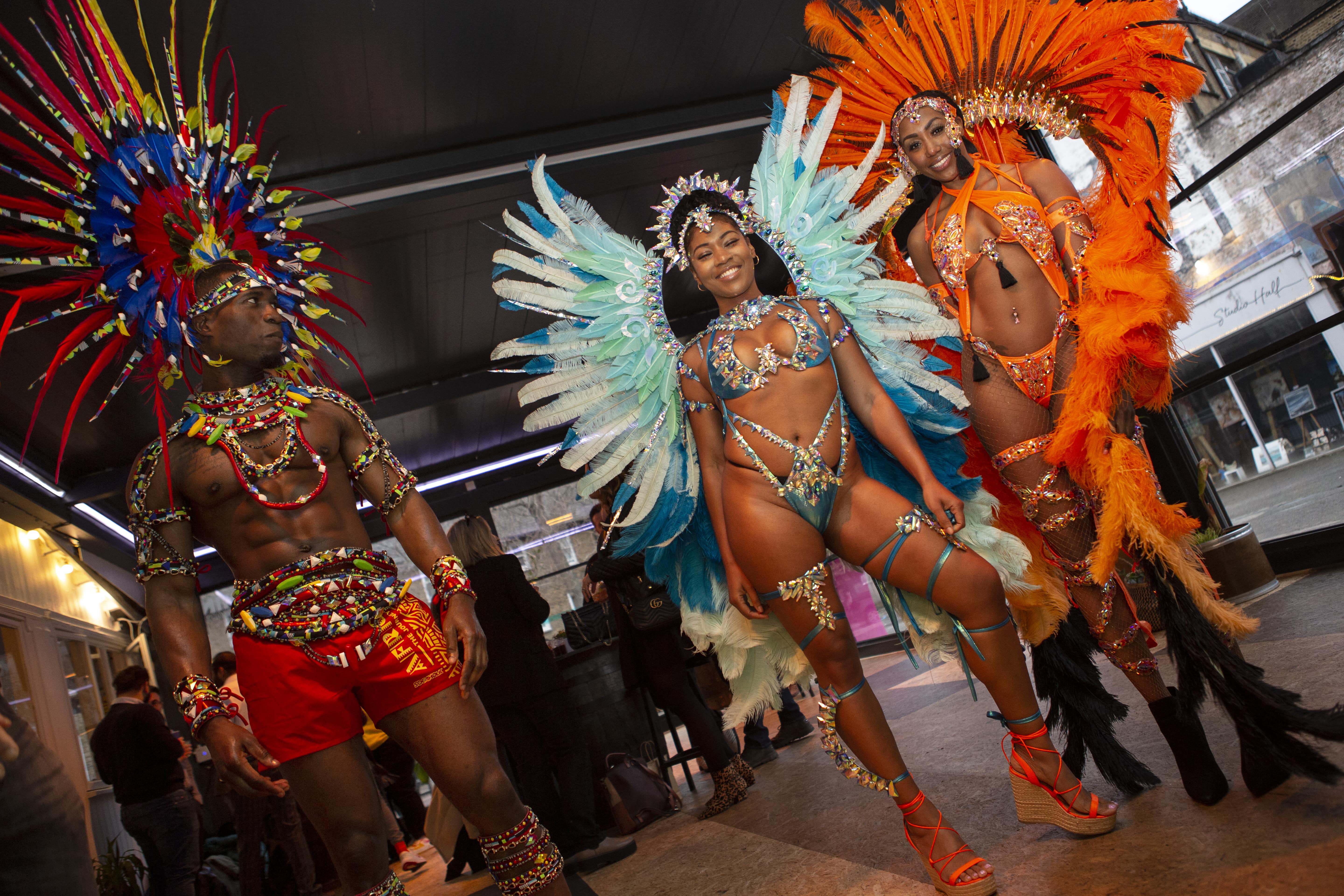 Vibrant cultural performance at L'Chalet, featuring feathered headdresses for events.