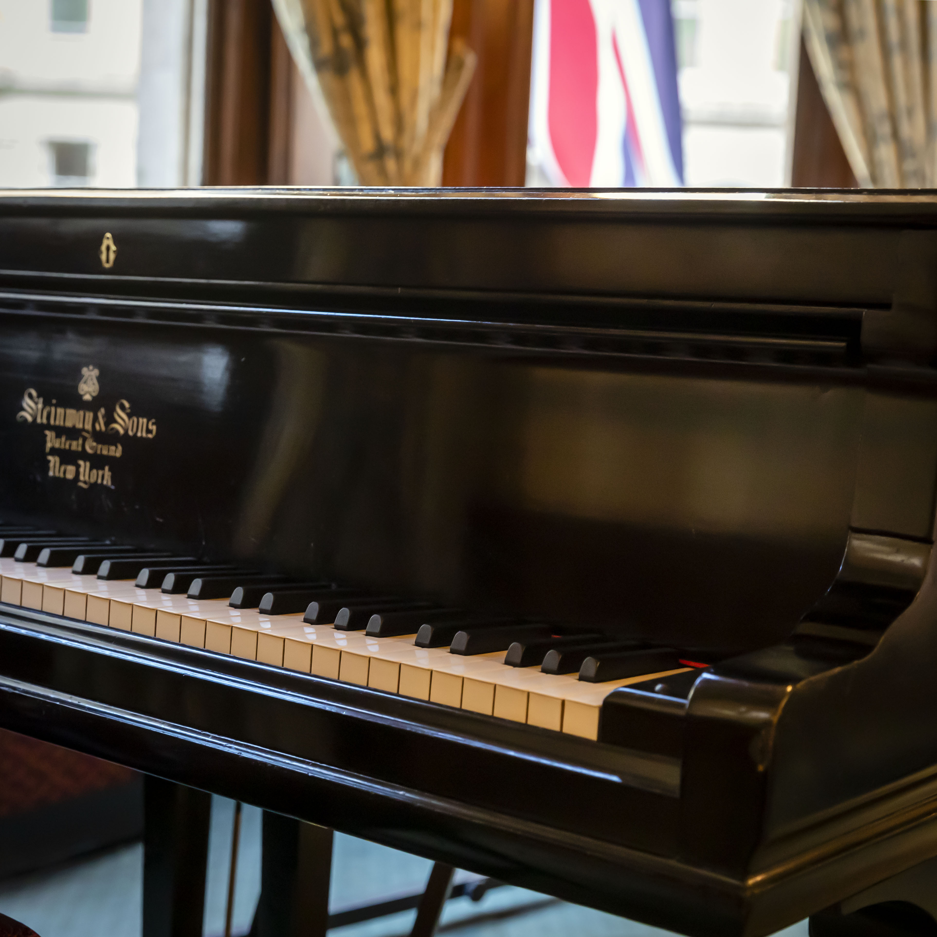David Lloyd George Room with polished grand piano, perfect for receptions and gala dinners.