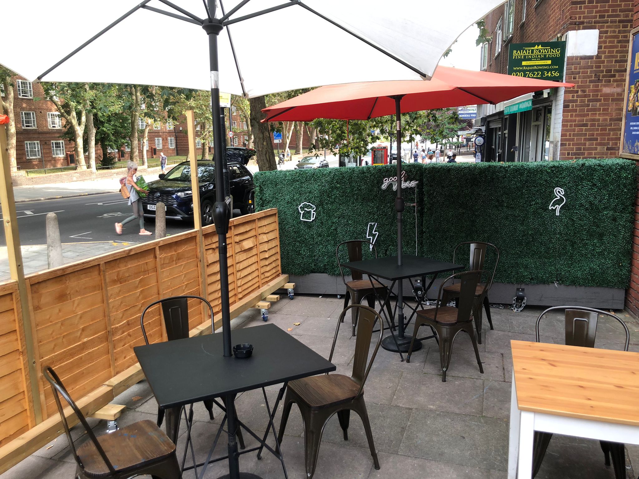Outdoor event space at Neptune Bar with tables, chairs, and greenery for networking.