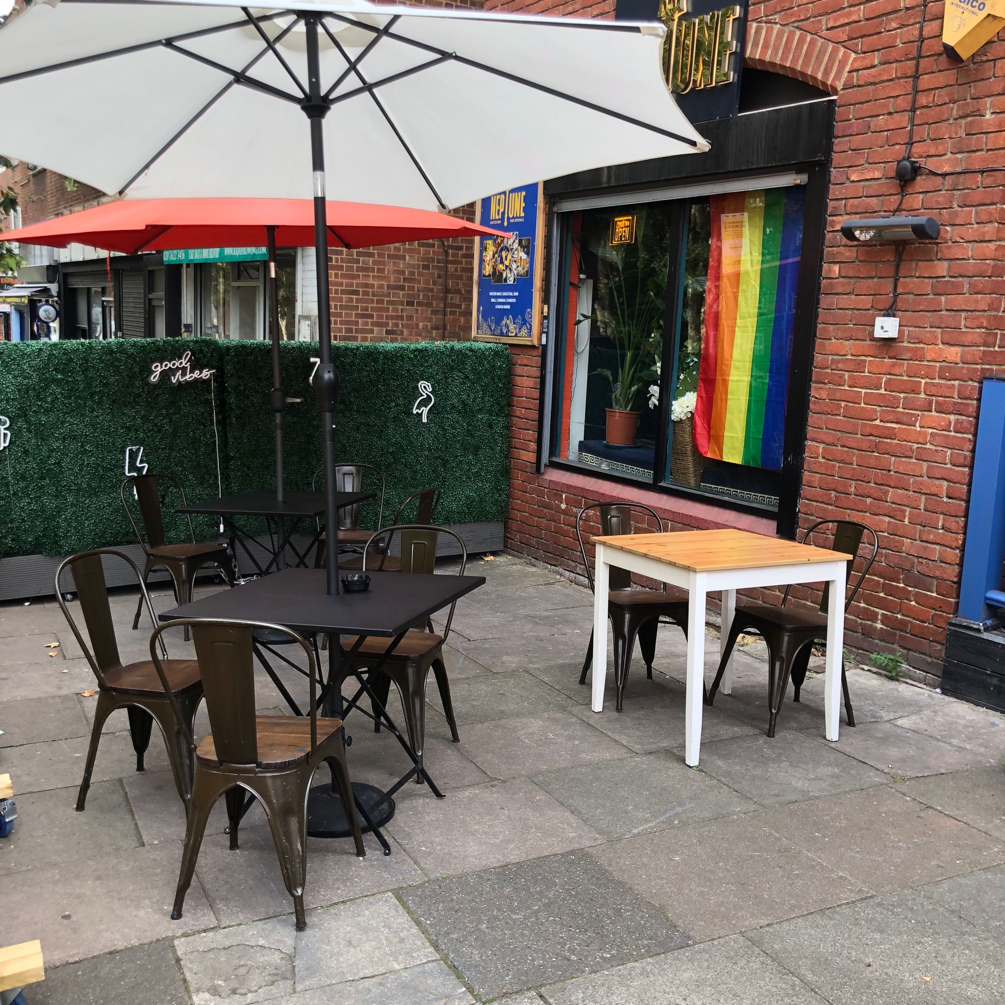 "Neptune Bar outdoor space with colorful decor, perfect for casual meetings and events."