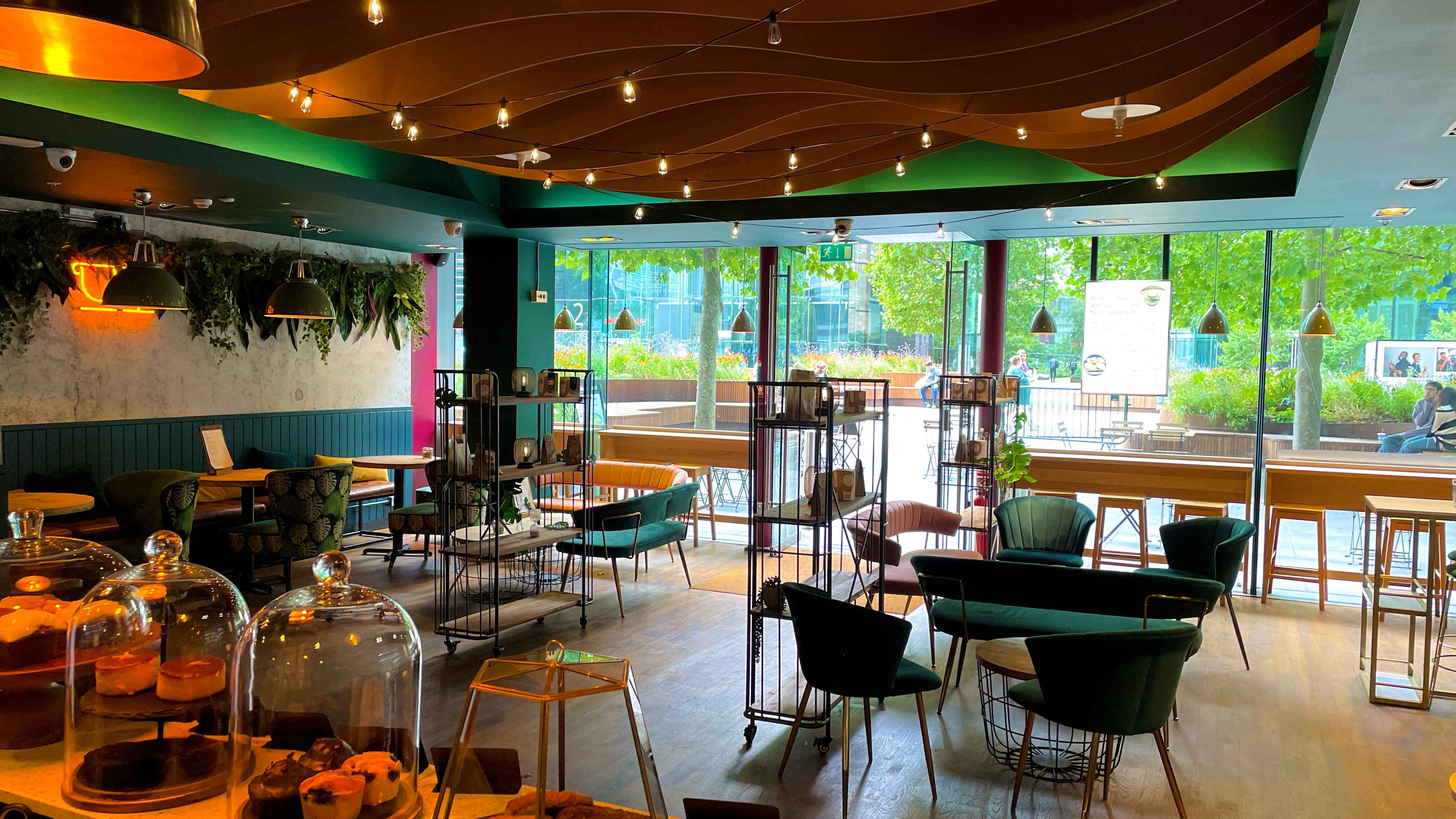 Vibrant meeting space with greenery, ideal for networking events and casual gatherings.