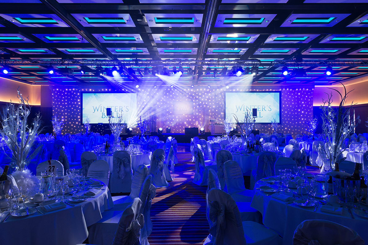 Elegant banquet hall with blue lighting for a London Suite Christmas party gala.
