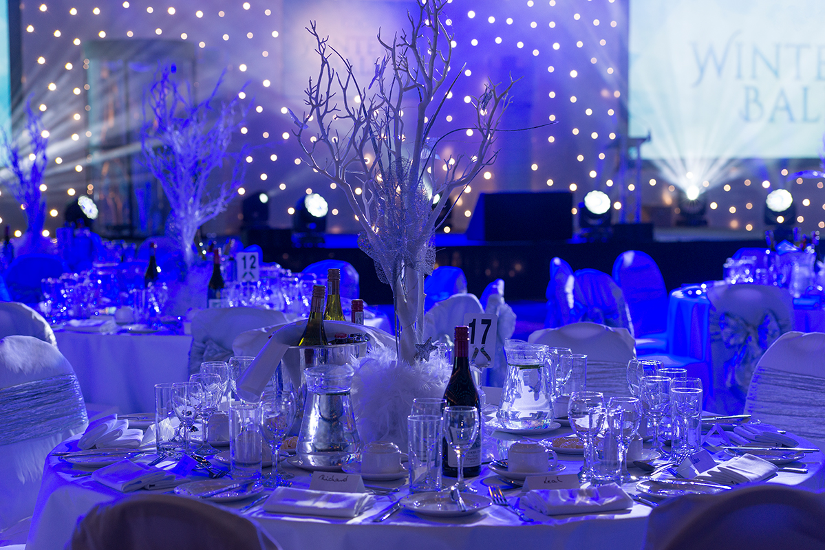 Elegant banquet table with frosted branches for a London Christmas party.