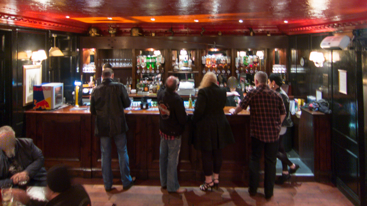 Lively sports bar with warm lighting, perfect for networking events and social gatherings.