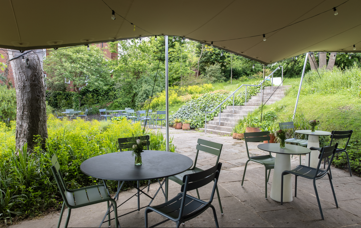 Serene outdoor event space with canopy and greenery at Camden Art Centre for gatherings.