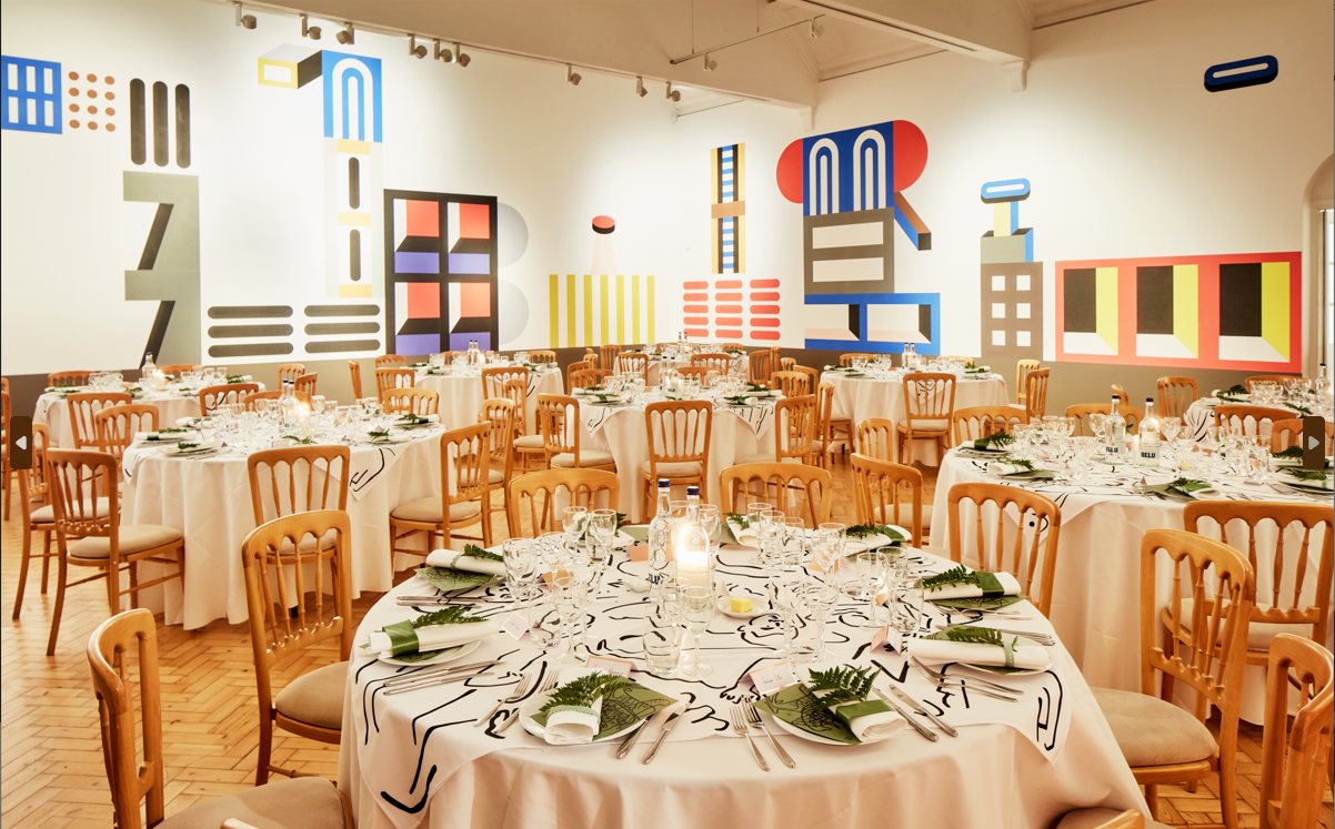 Elegant dinner setup in Camden Art Centre with abstract art, perfect for corporate events.