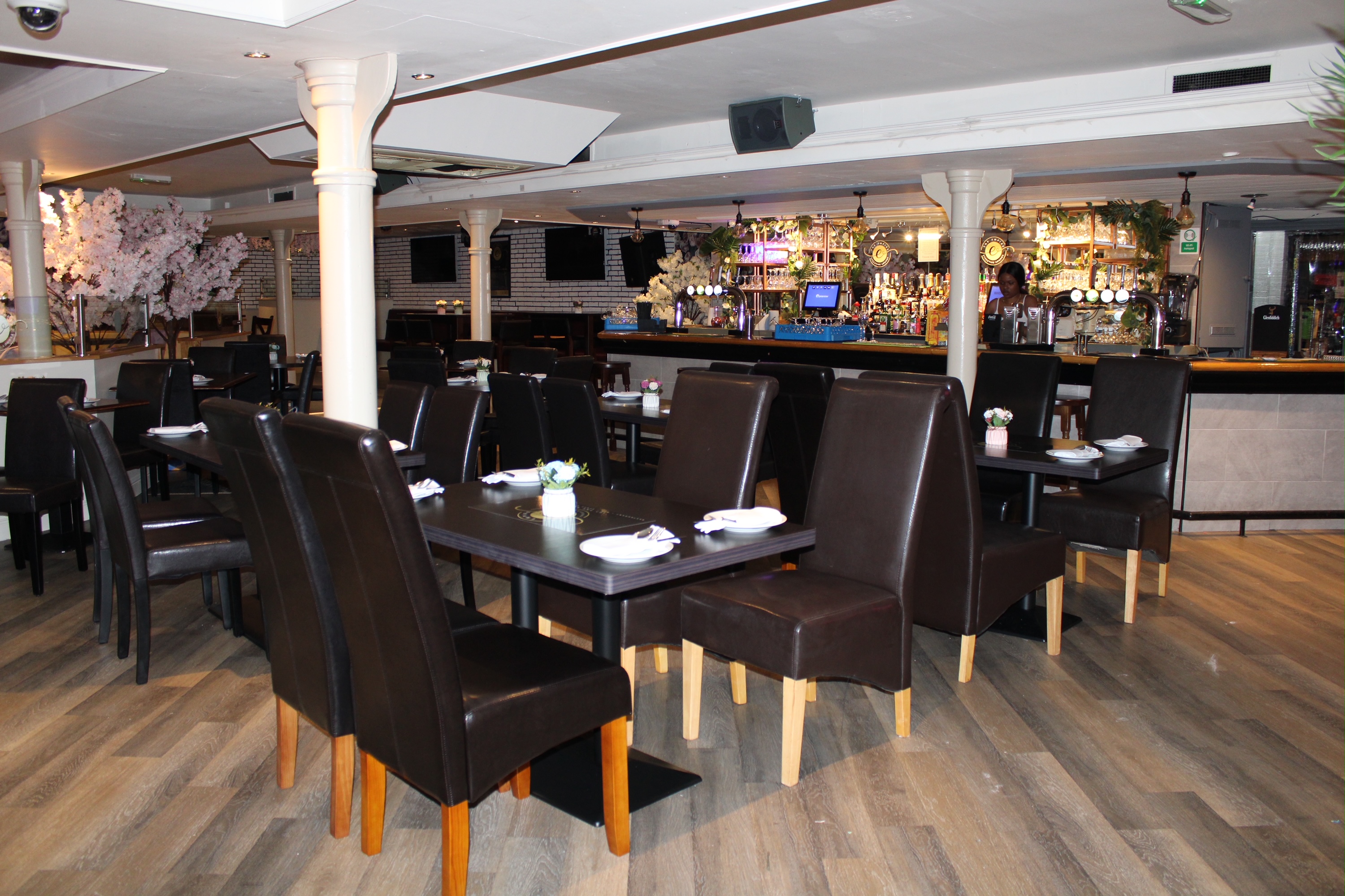 Private room in Empire Executive Lounge with dark wood tables for meetings and events.