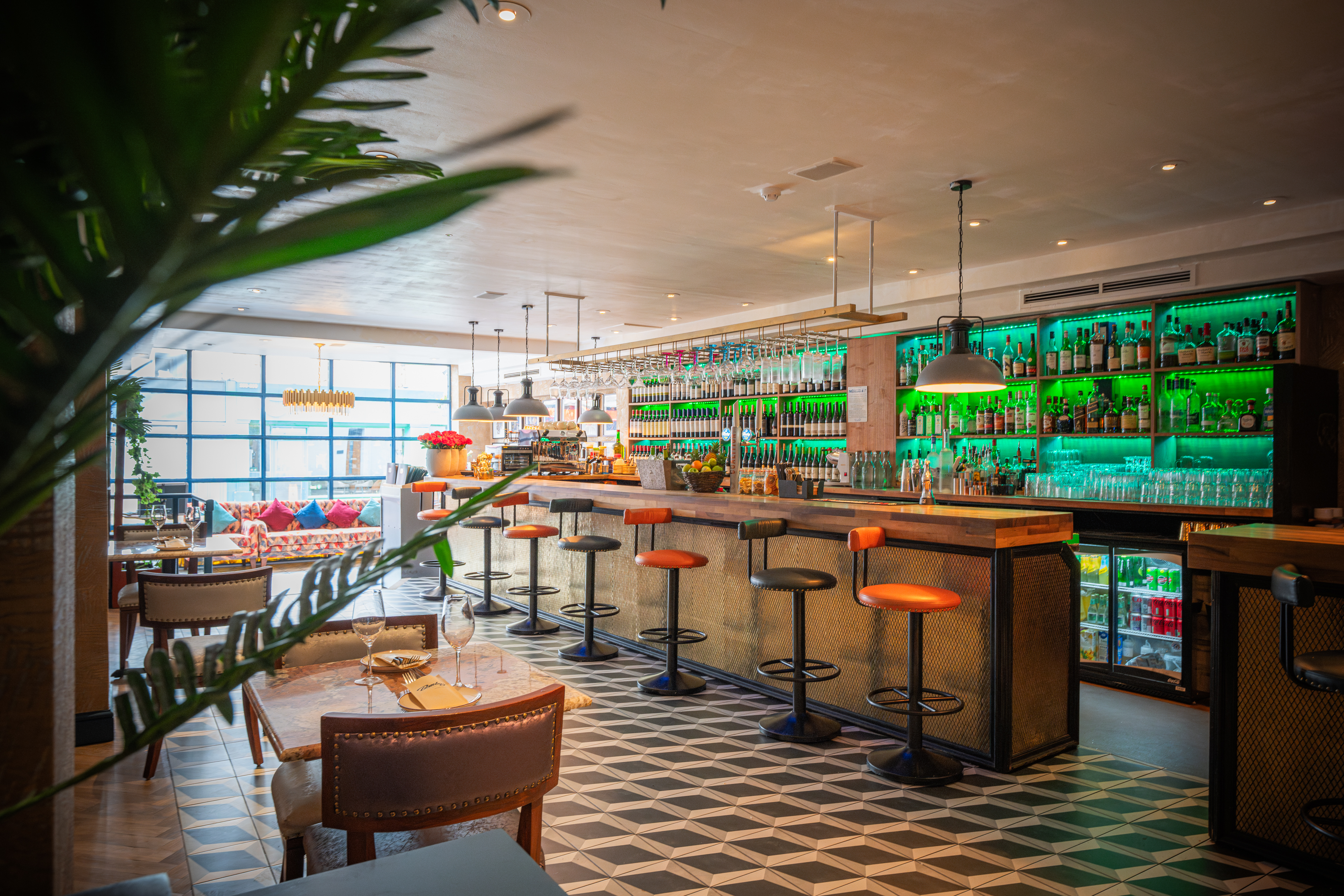 Private dining area at Bombay Delight with vibrant green lighting, perfect for networking events.