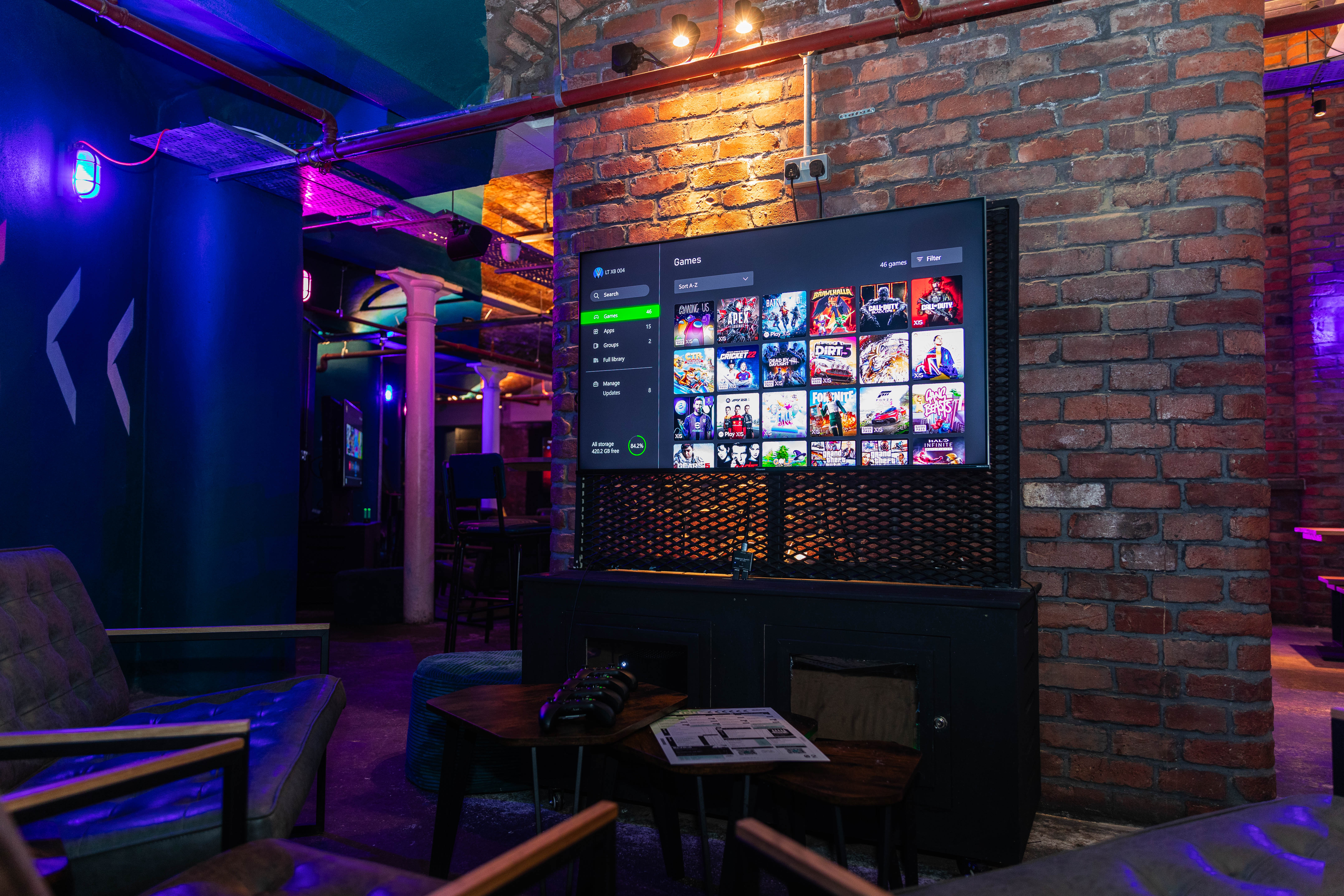 Modern event space with large screen, ideal for networking and casual gatherings.