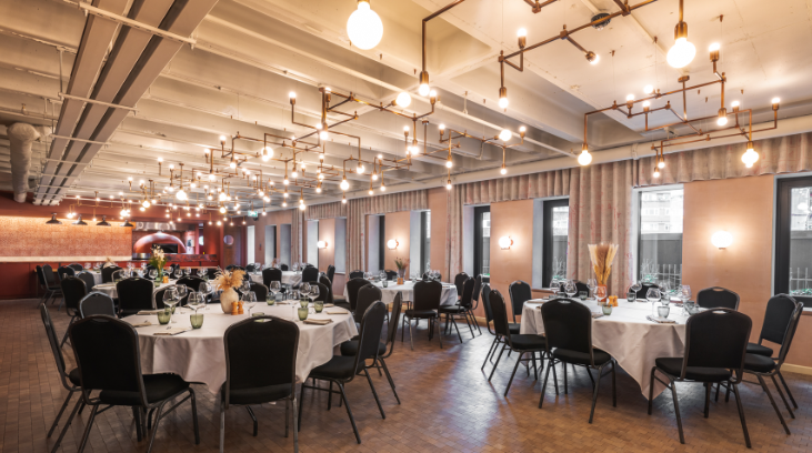 Elegant event space with round tables, ideal for formal dinners and networking.