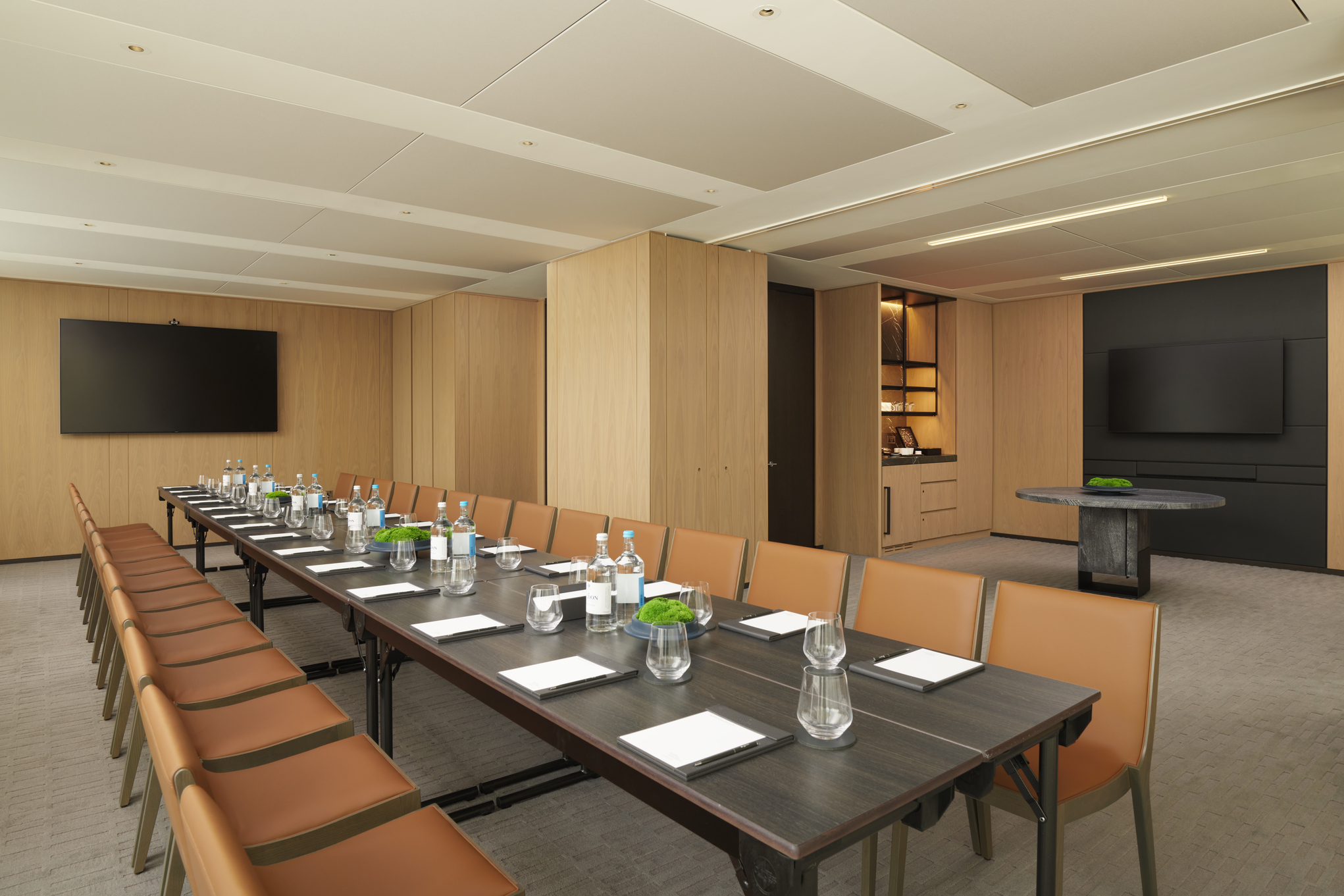 Modern meeting room in Pan Pacific London, featuring a long table for corporate workshops.