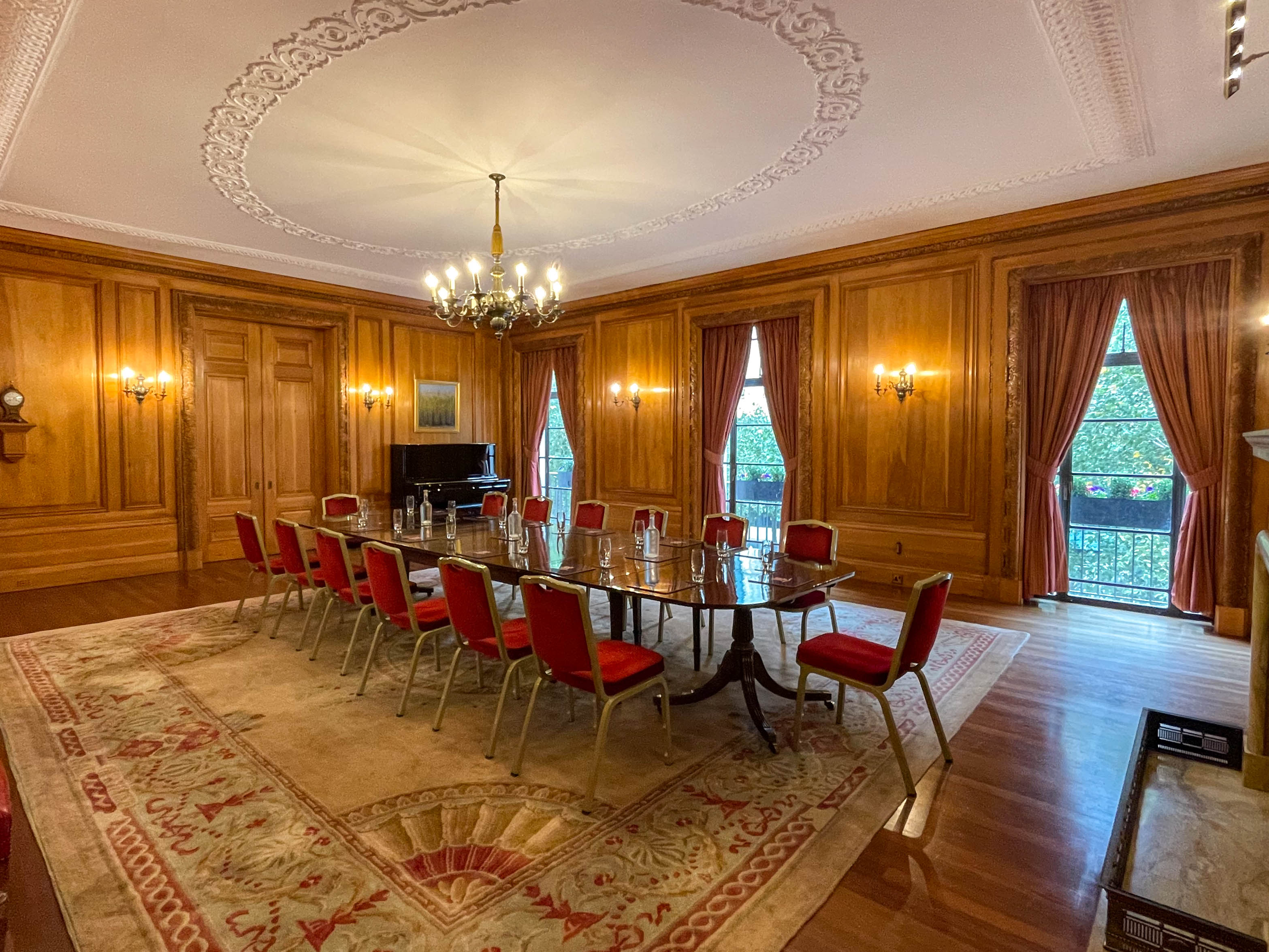 Elegant meeting room with wood paneling, ideal for corporate events and gatherings.
