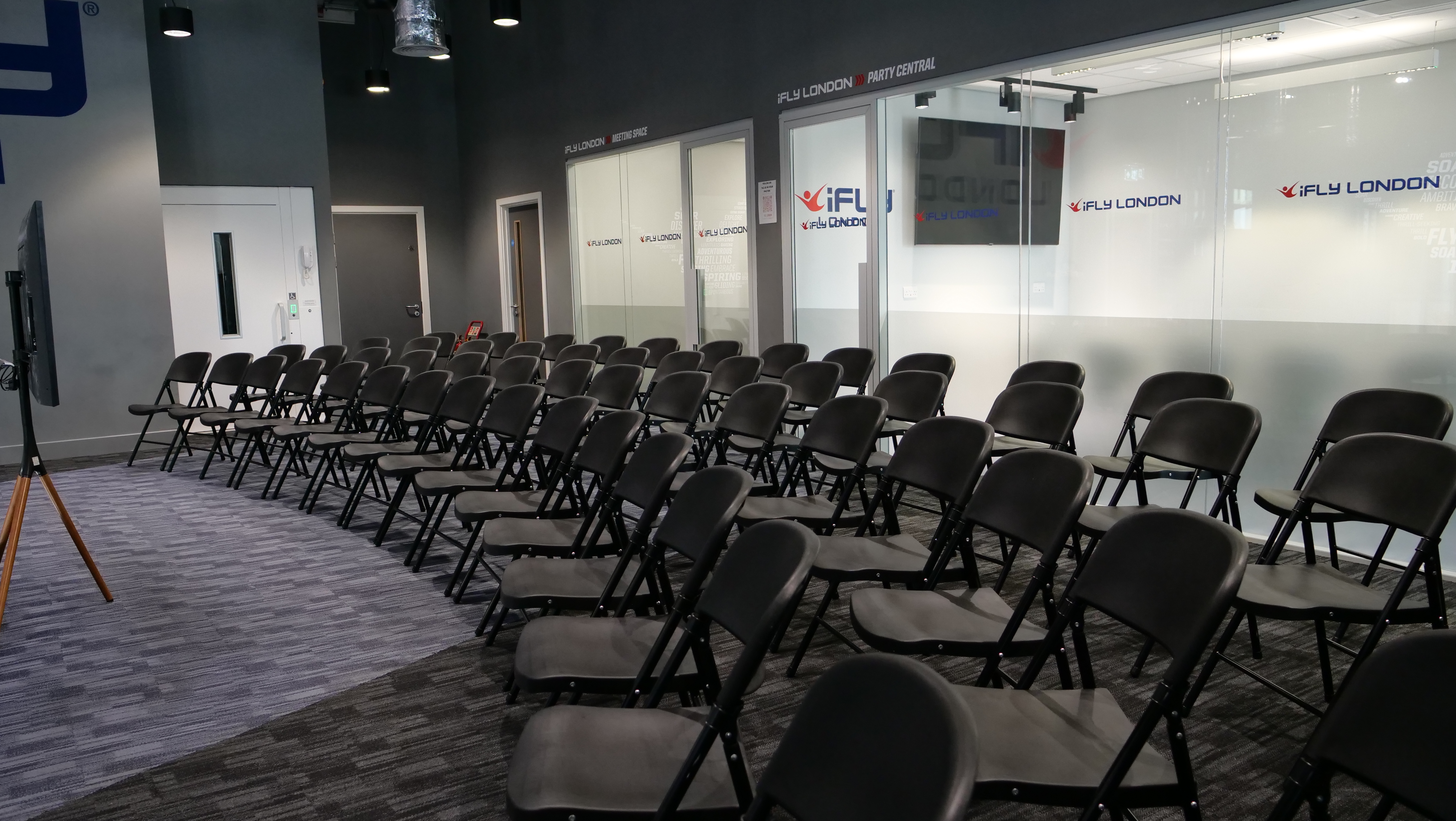 iFLY Indoor Skydiving meeting space with black chairs for presentations and workshops